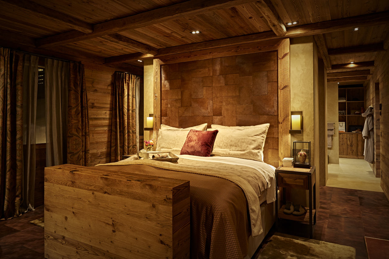 Master bedroom with dressing room and balcony access in Chalet 1551 in Lech