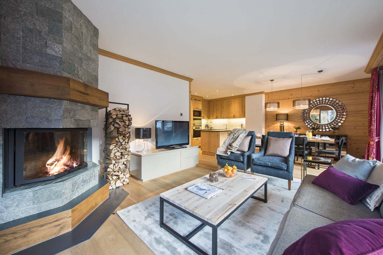 Fireplace and TV in living room of Chalet Elena in Zermatt