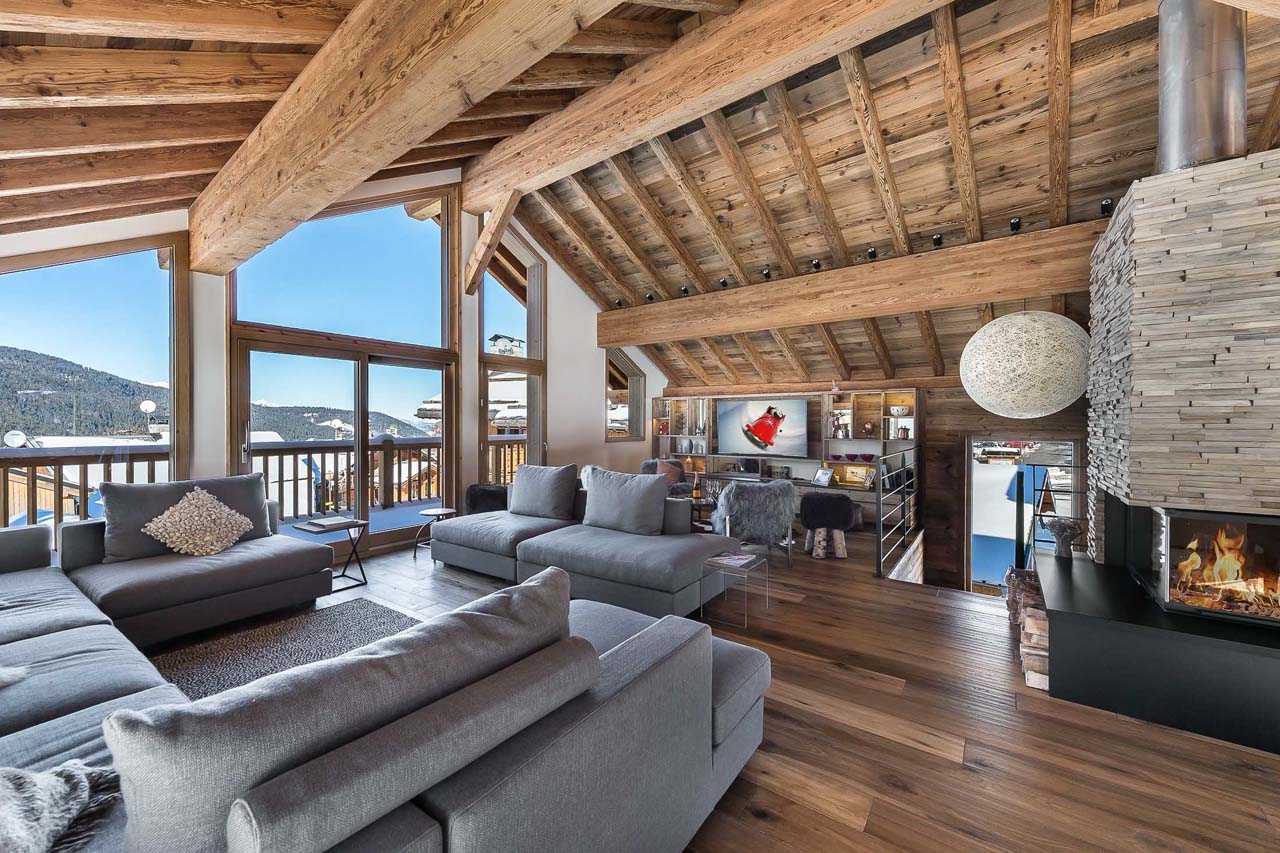 Fireplace and sofas in living area of Chalet Fontany in Meribel