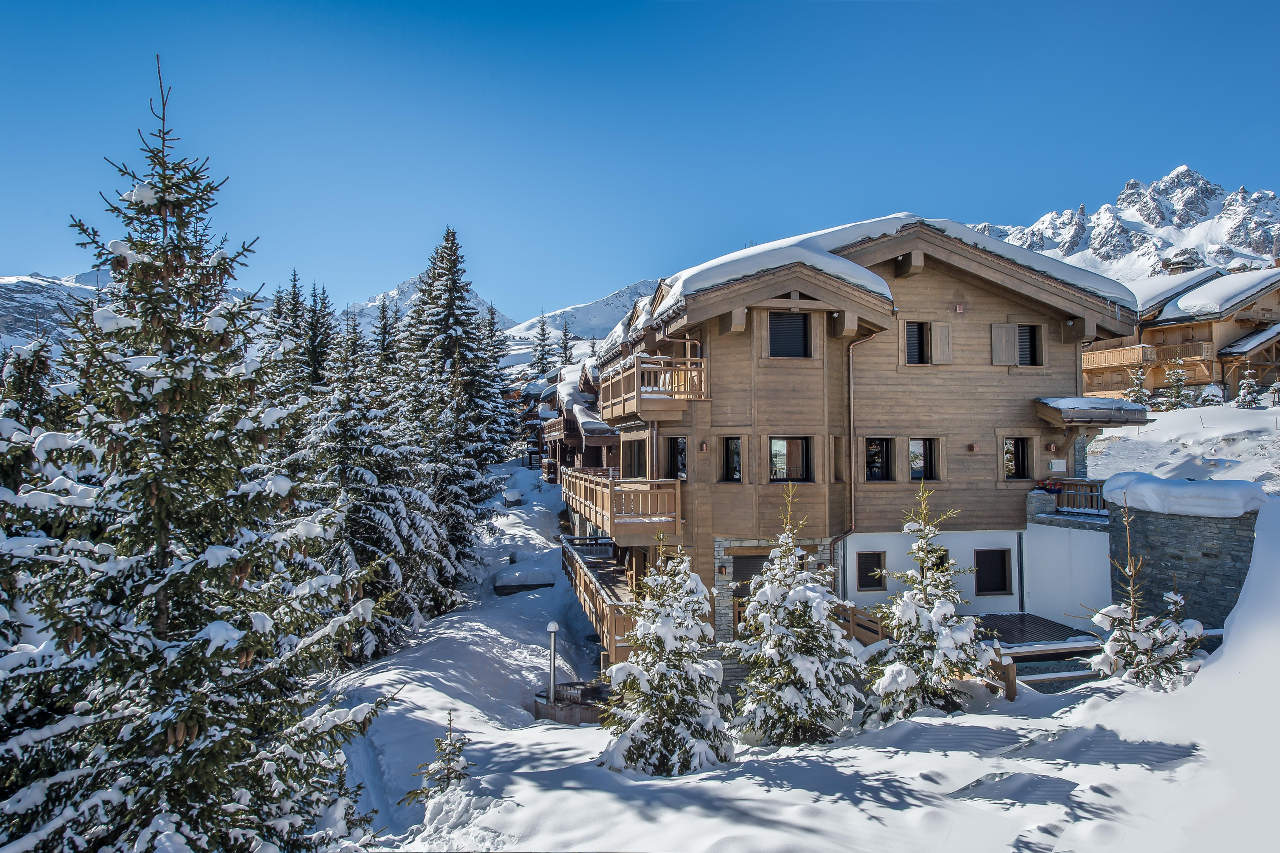 Chalet Perce Neige in Courchevel 1850, surrounded by fir trees