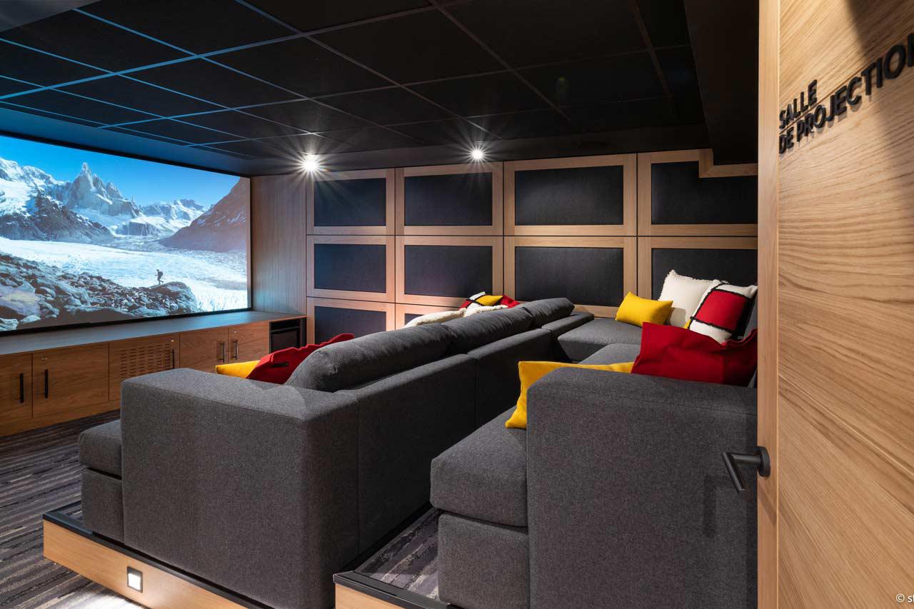 Cinema room with 4K video projector and large screen at Chalet Arpoza in Les Arcs