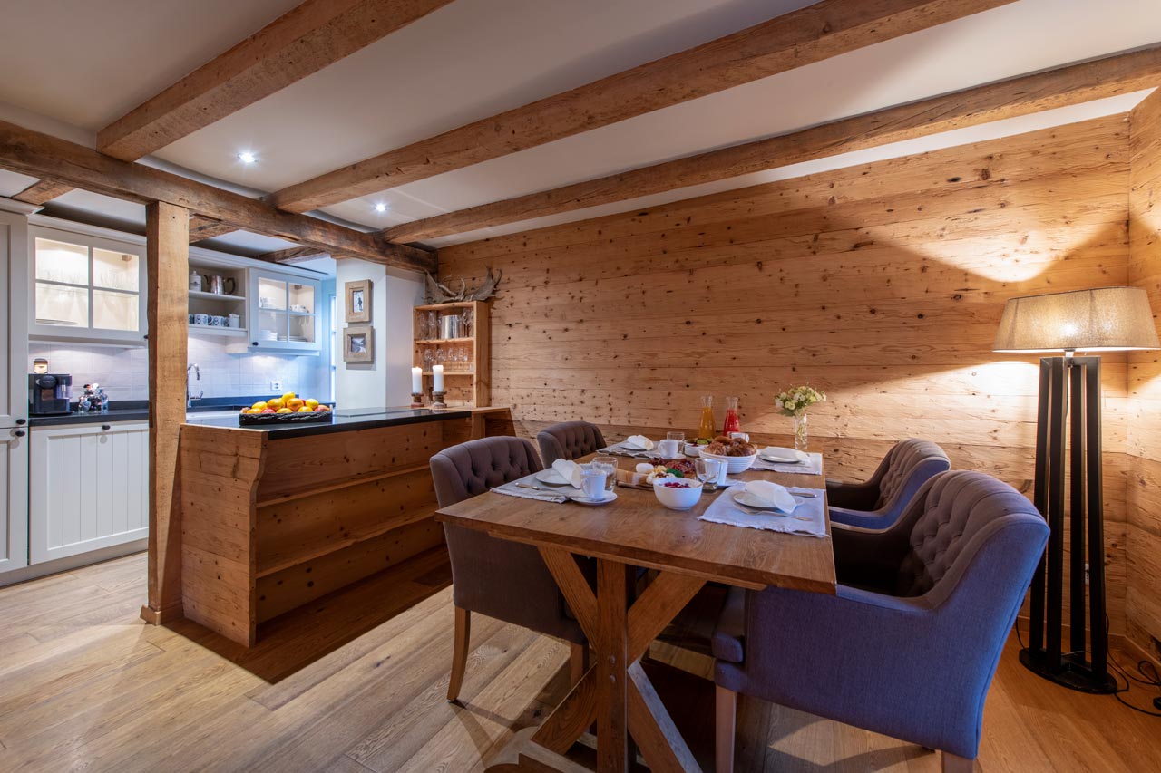 Dining table and kitchen at Chalet Chocolate Box in Davos