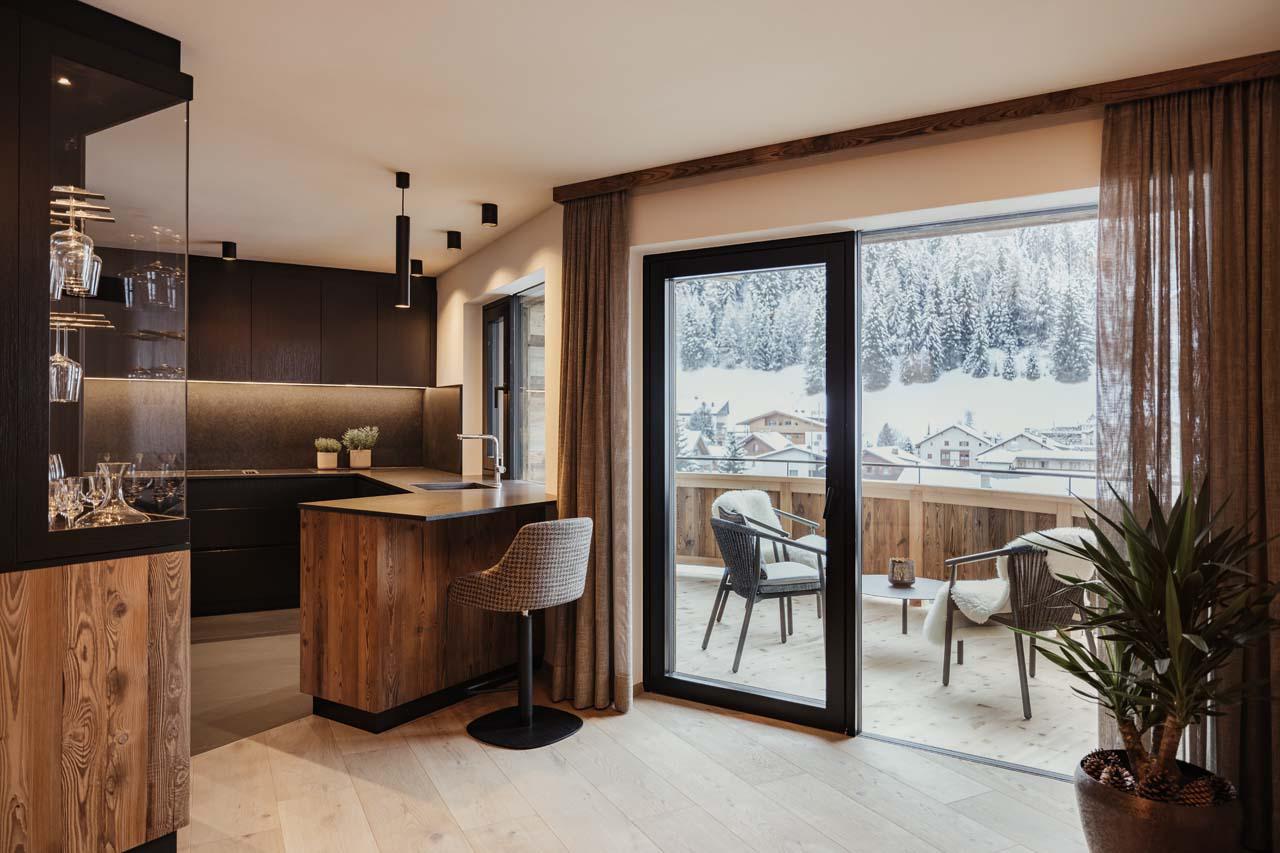 Spacious living area with kitchen and private balcony at Chalet Mile 1 in Val Gardena