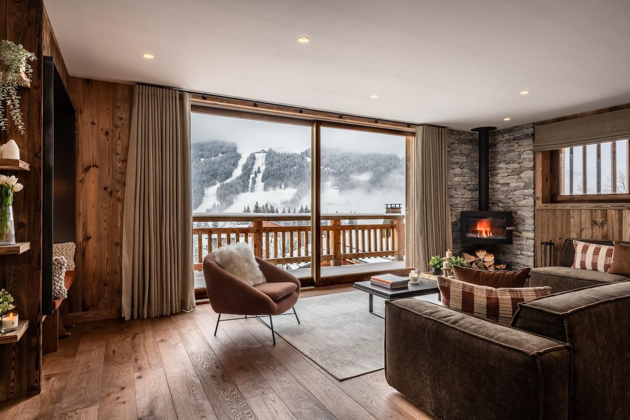 Large sofa space with wood-burning fireplace at Tosca in Les Gets