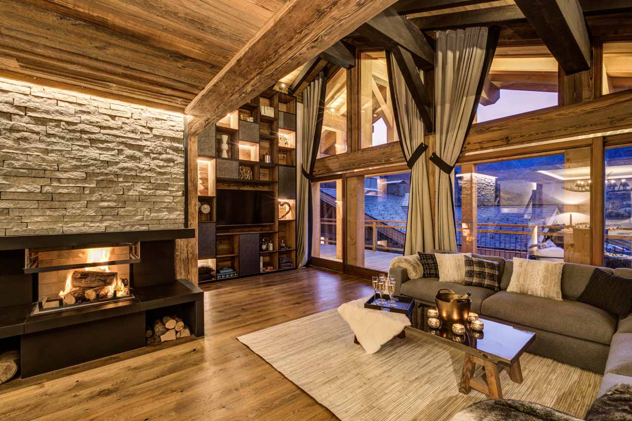 Open plan living area with fireplace at Chez Bugi in St Martin de Belleville