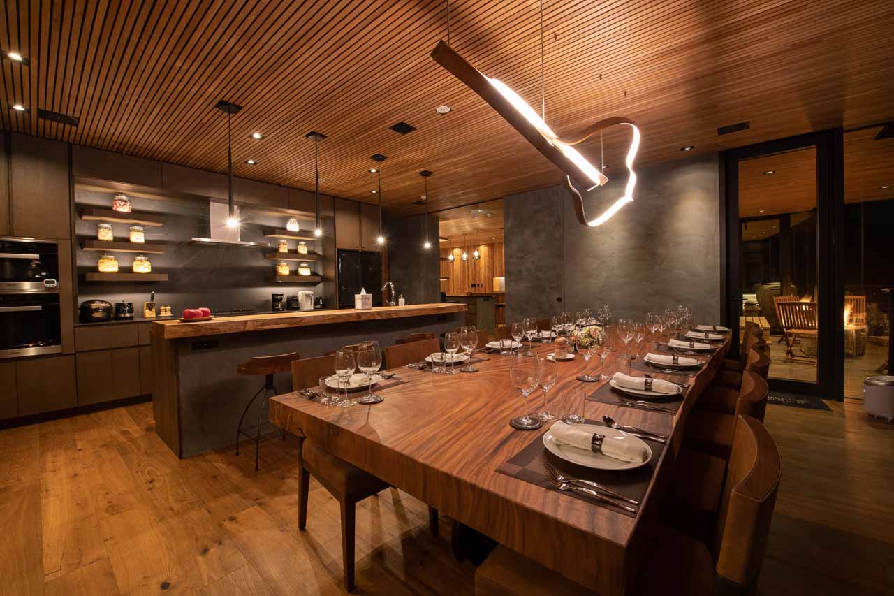 Dining room and kitchen at HakuVillas in Niseko at night