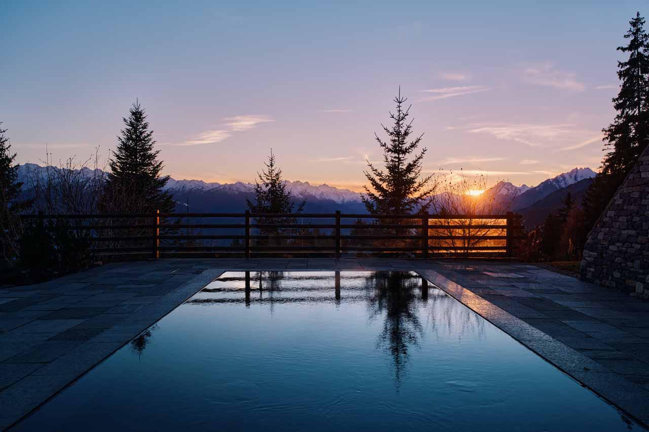 Outdoor swimming pool at night in Prestige Apartment LeCrans