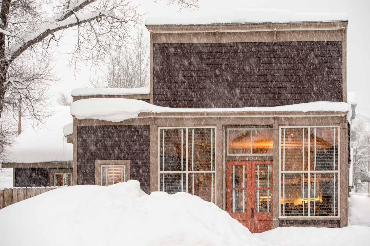Snowy chalet exterior of Sopris House in Crested Butte
