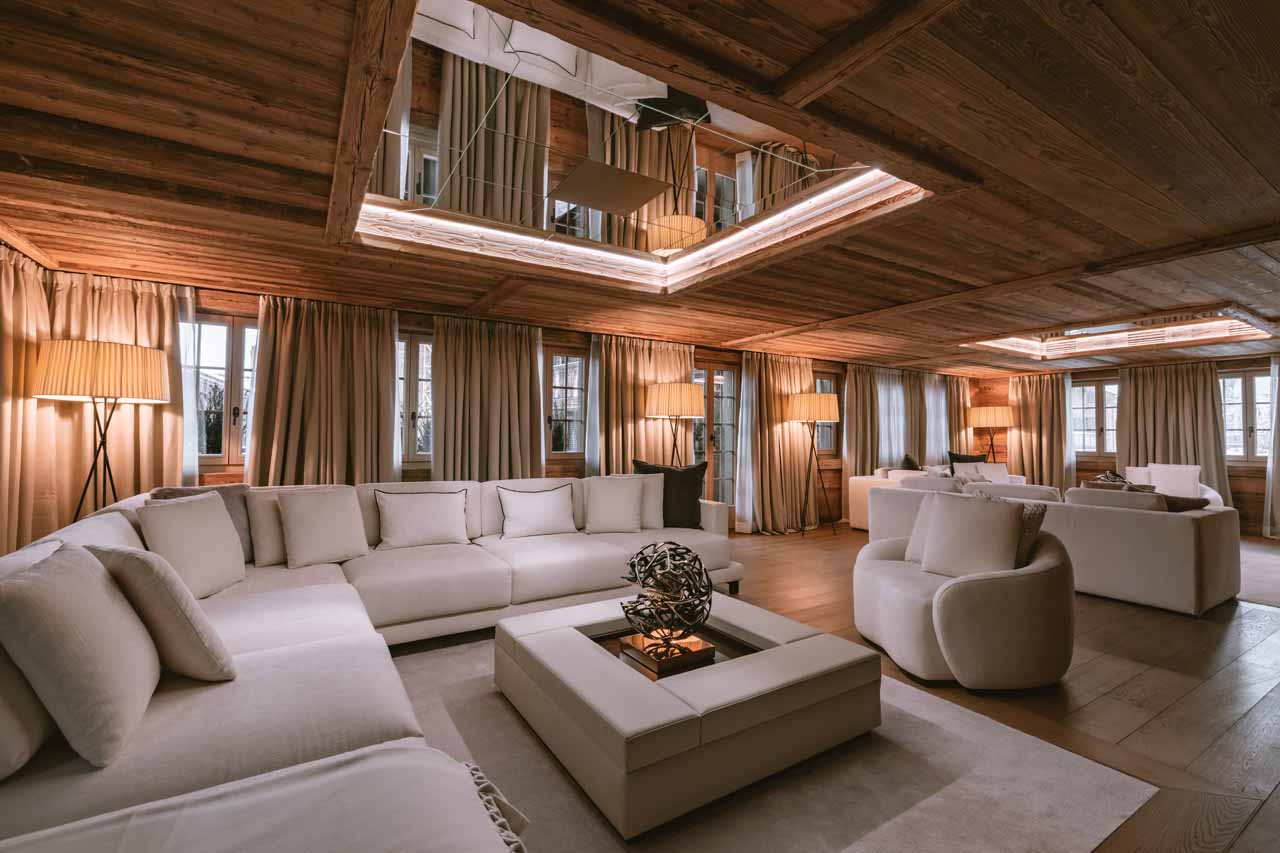 Expansive living room with sofas and fire in Ultima Gstaad Promenade, Gstaad