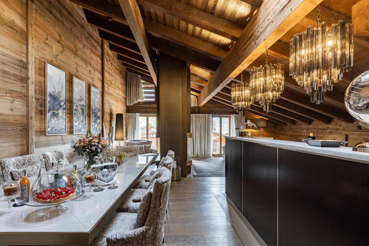 Dining area and kitchen at Ultima Gstaad 2BR Residence in Gstaad