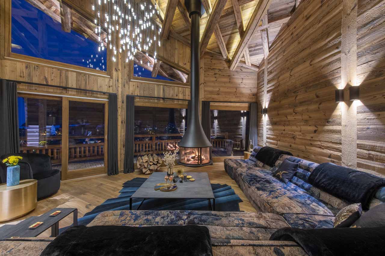 Wood-burning fireplace in living area of ZEMS Lodge in Morzine