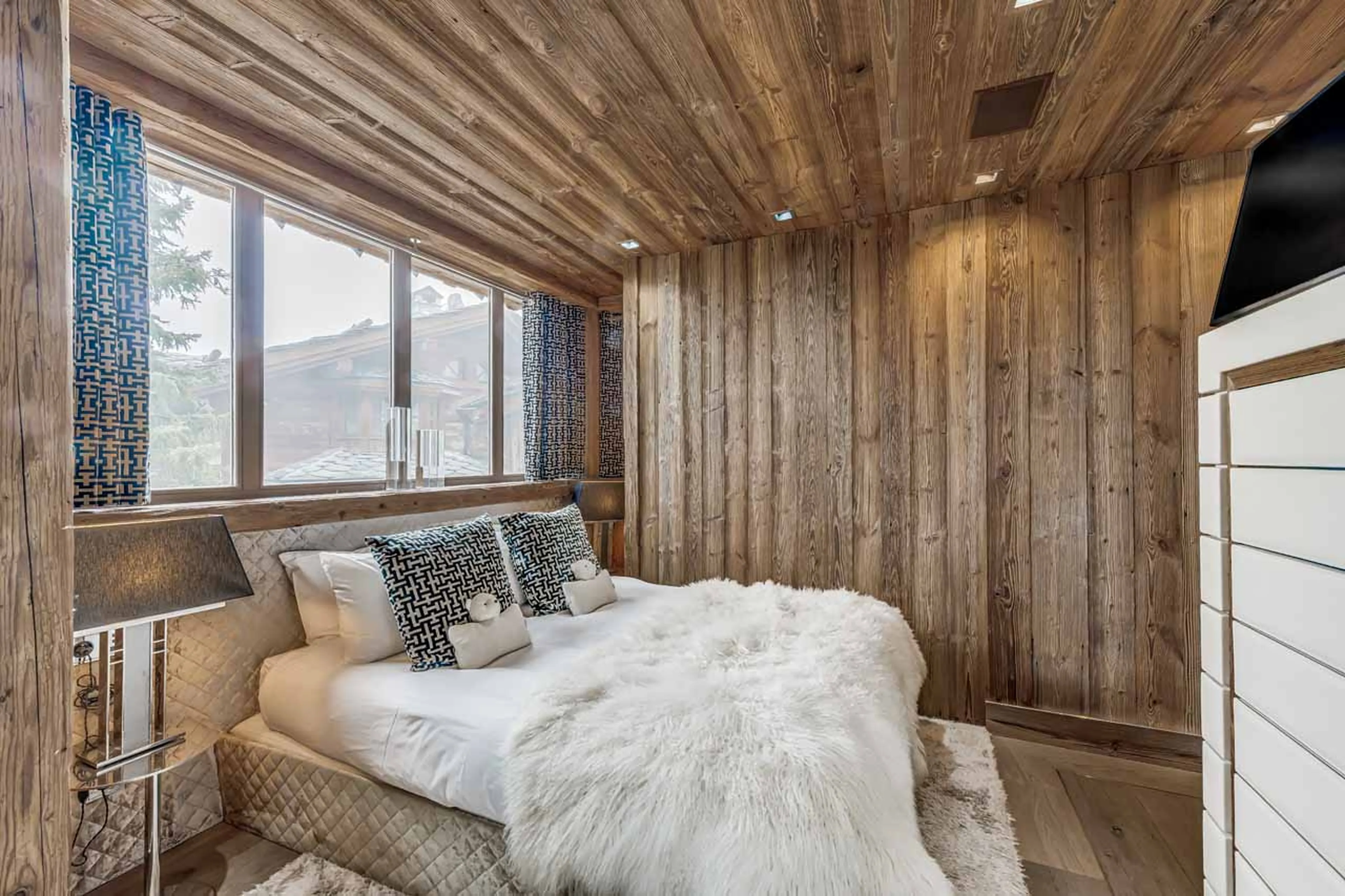 Bedroom with double bed and en suite shower room in Chalet Carat, Courchevel 1850