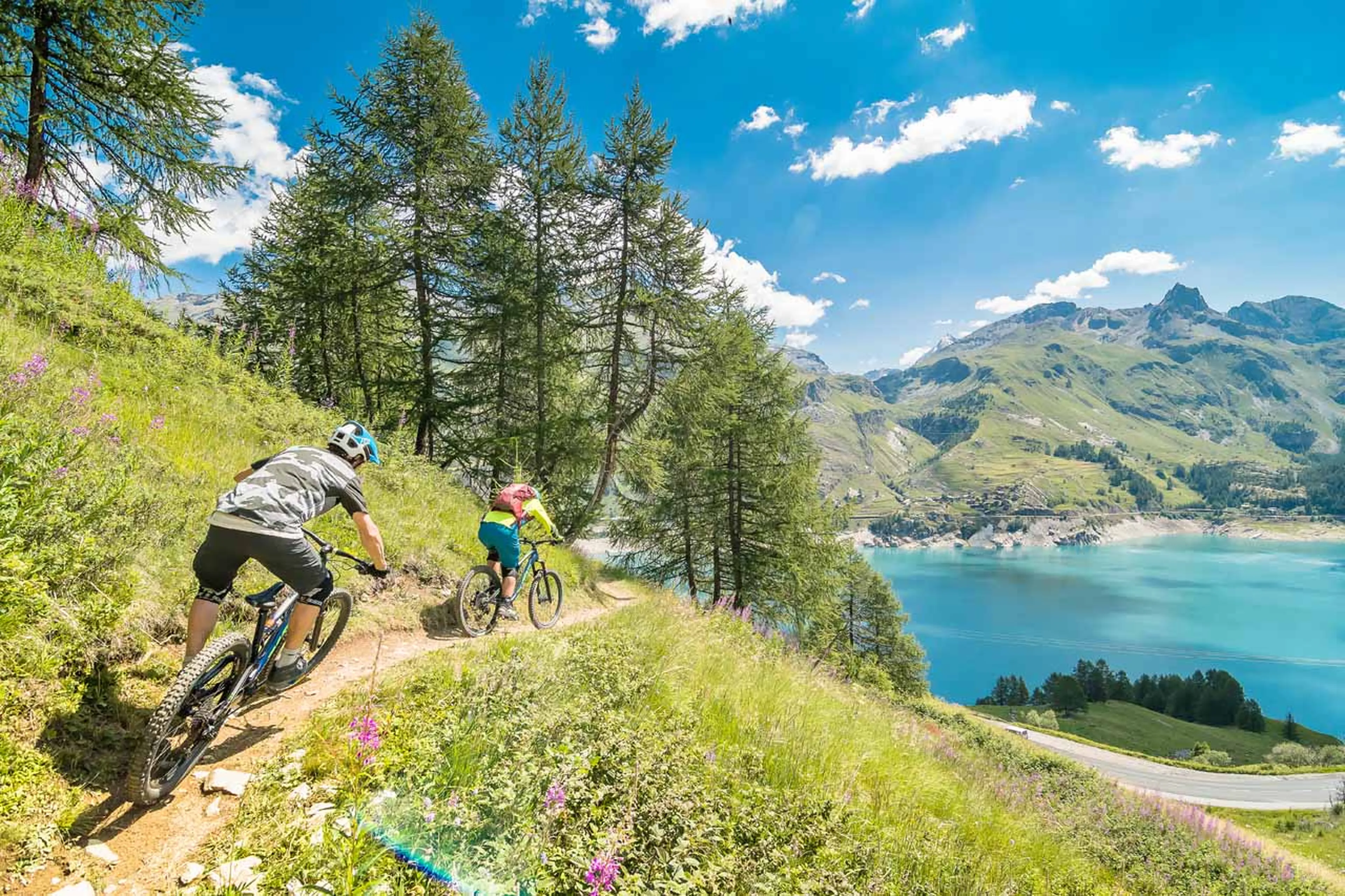 Mountain biking by the lake in summer in Tignes
