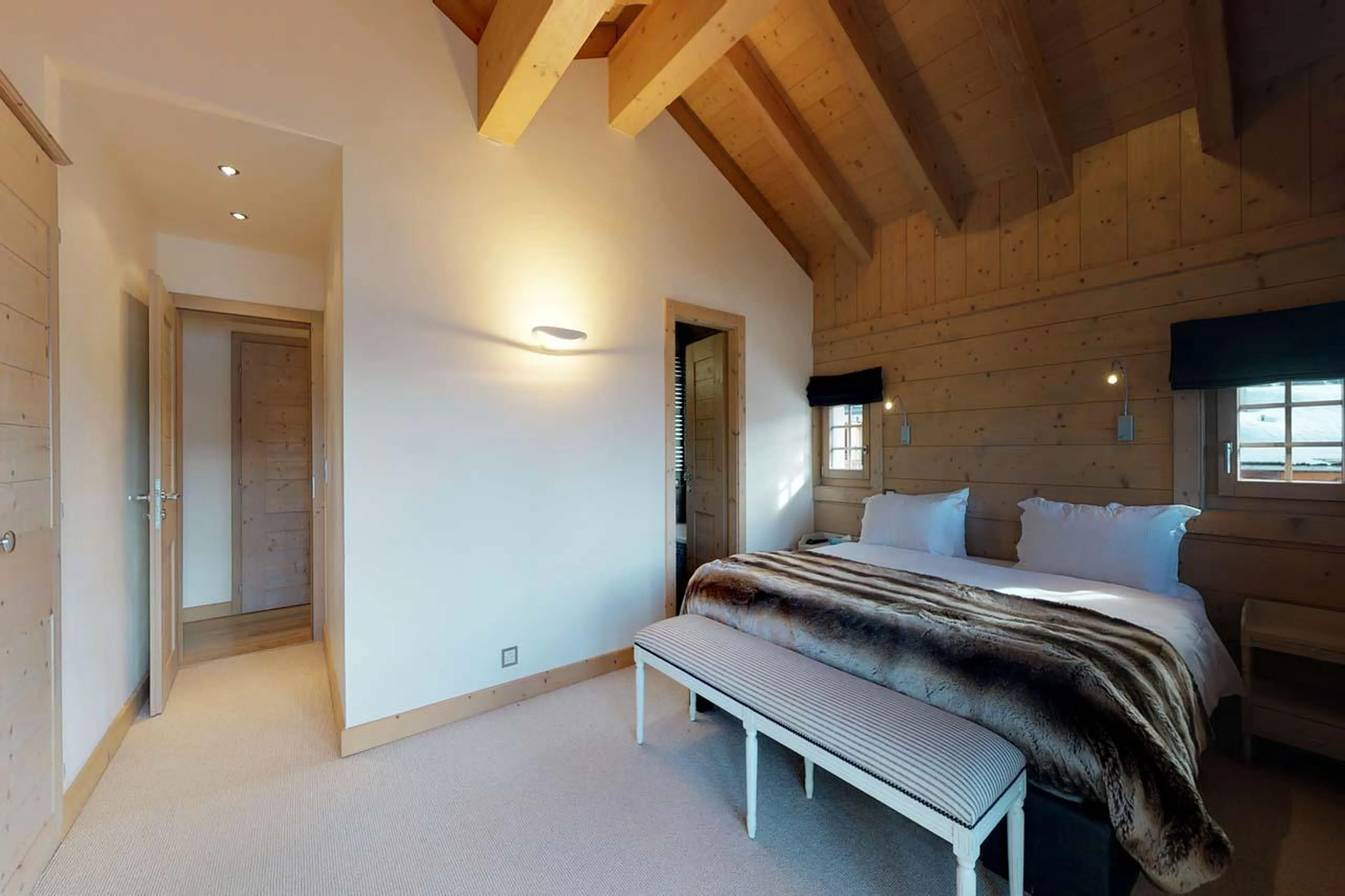 Master double bedroom with TV, balcony access and en-suite bathroom at Chalet Albert-Luc in Verbier