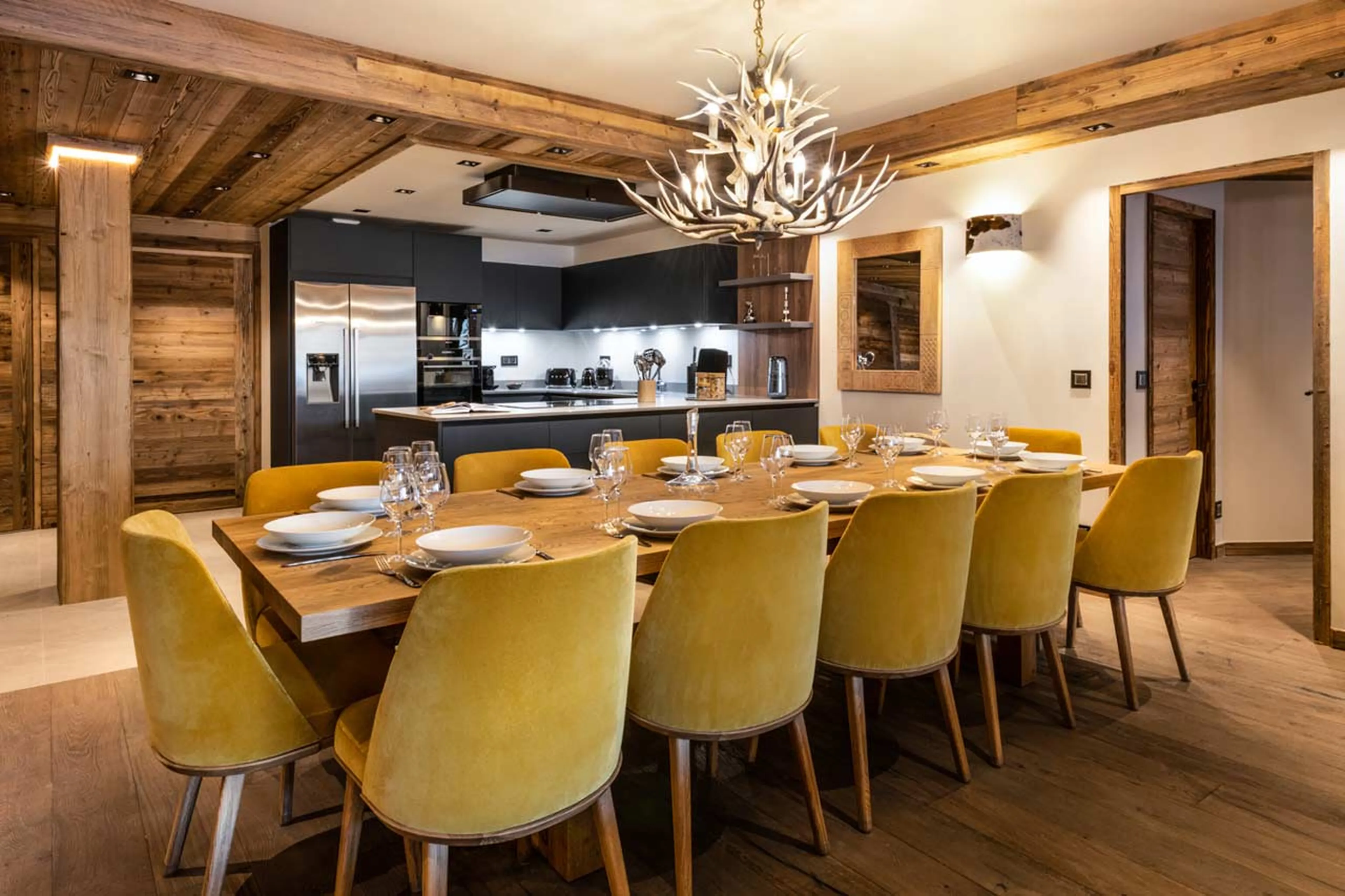 Dining table and kitchen at Alaska Lodge 4 in Val d'Isere