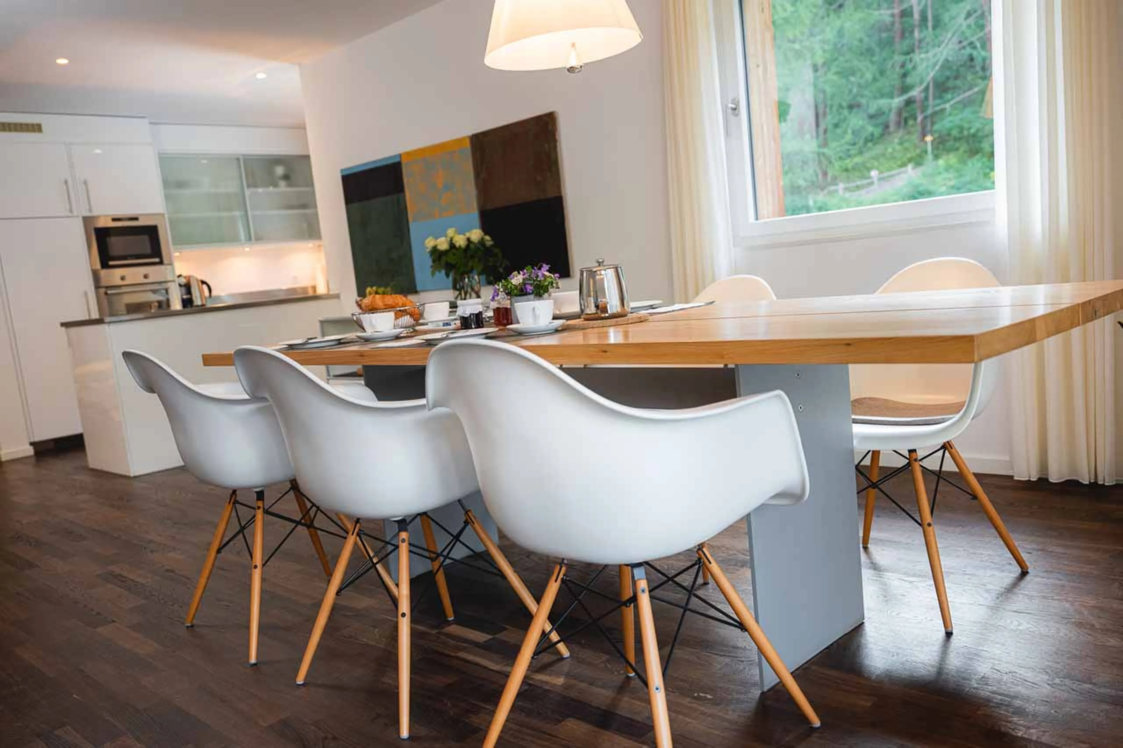 Dining area and kitchen at Open plan living area at Apartment Altesse 3 in Zermatt