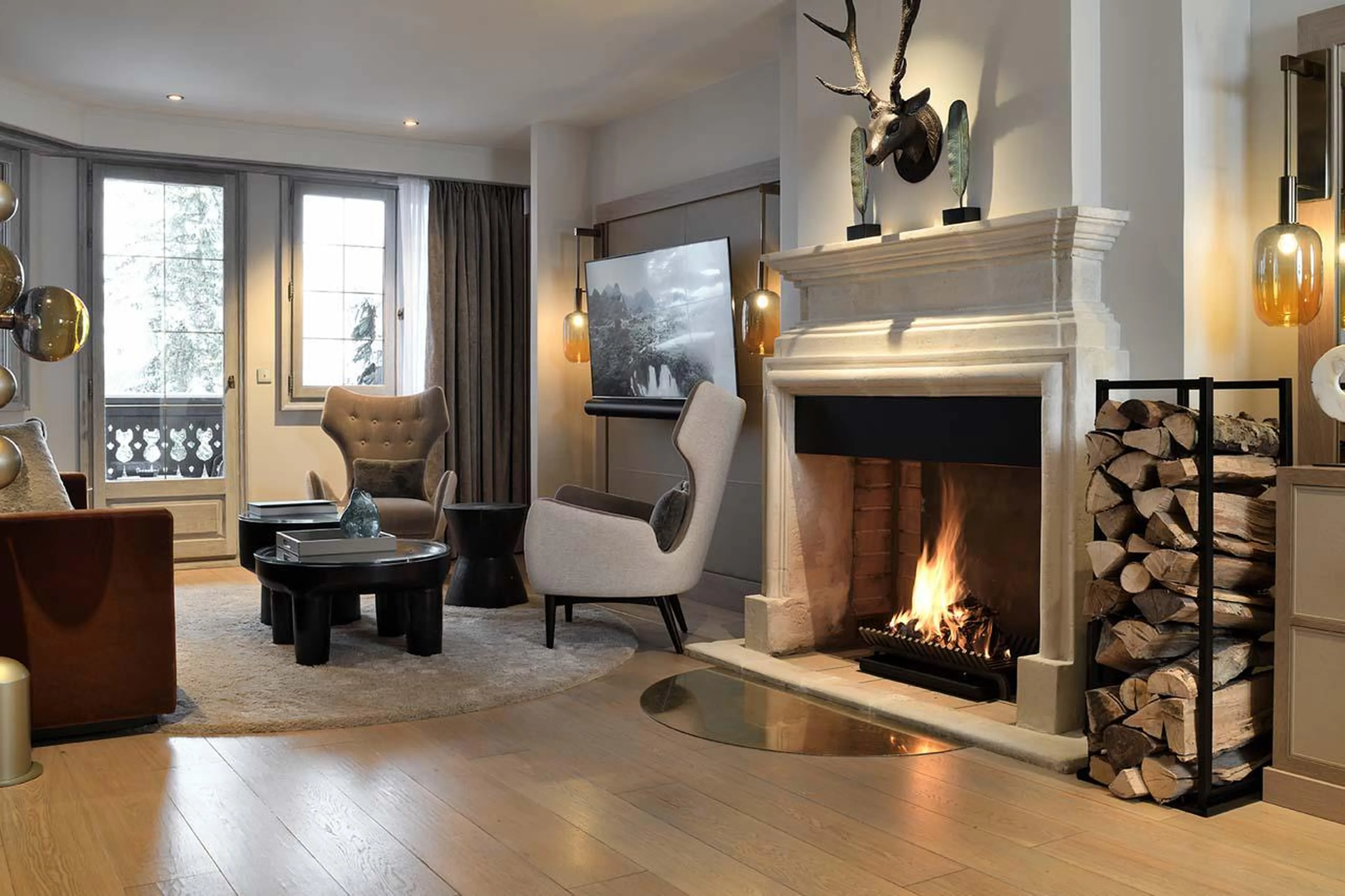 Open-plan living area with wood-burning fireplace at Apartment Ariondaz in Courchevel 1850