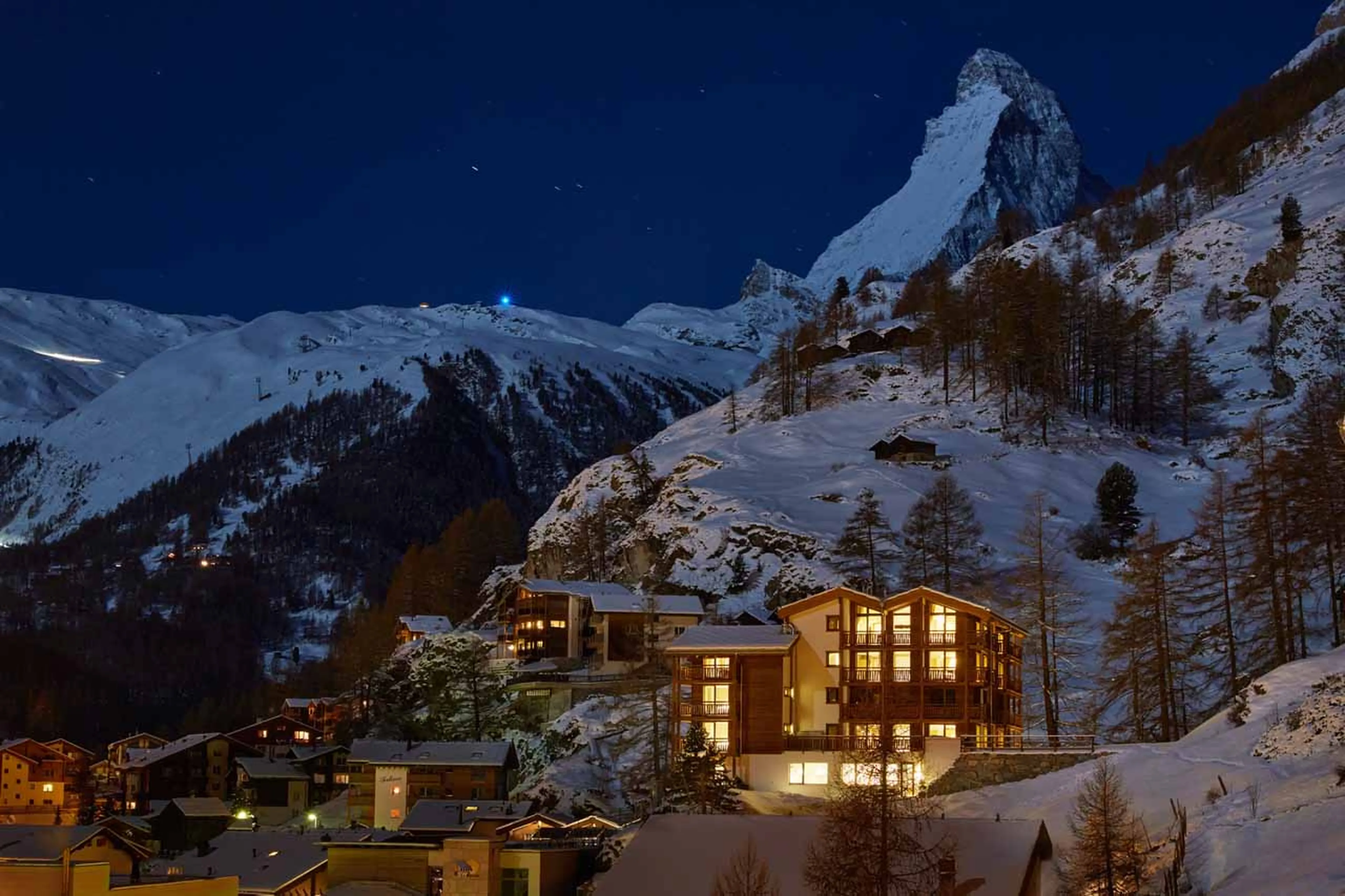 Exterior at night of La Vue apartments in Zermatt