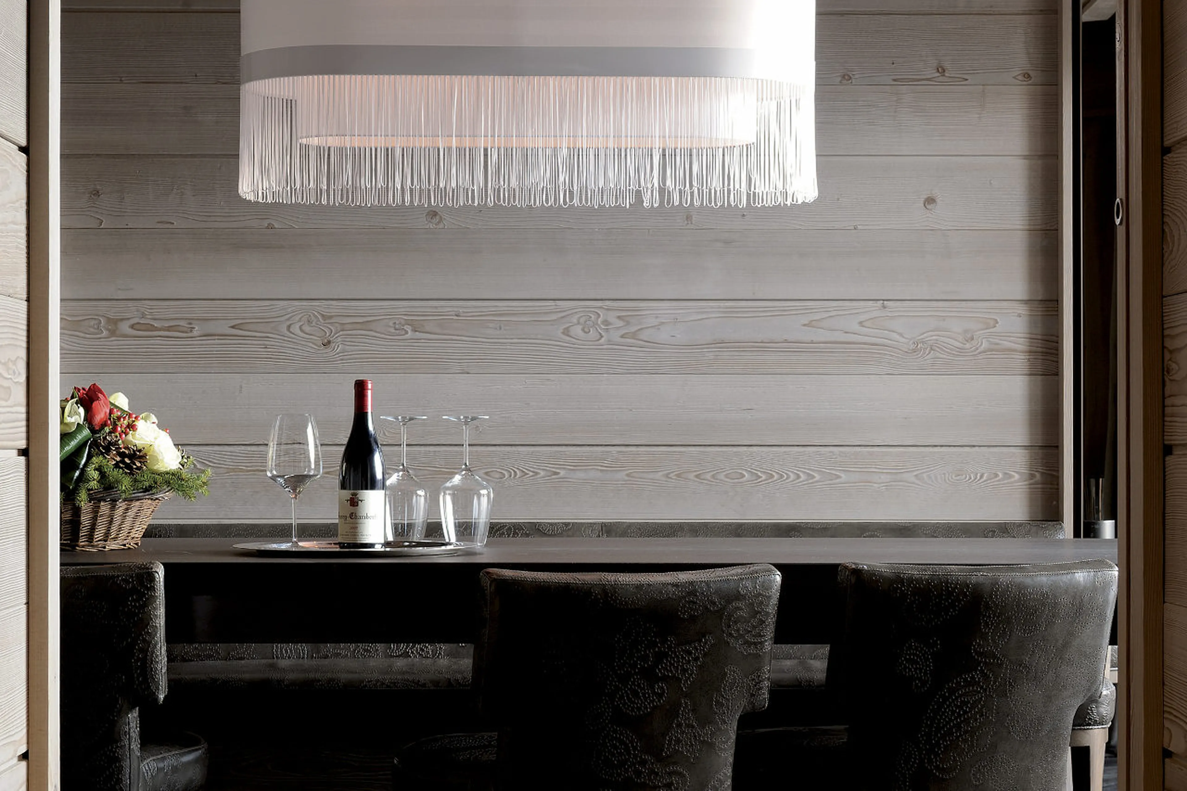 Curved chairs to match curved lampshade in dining room of Apartment Jade in Courchevel 1850