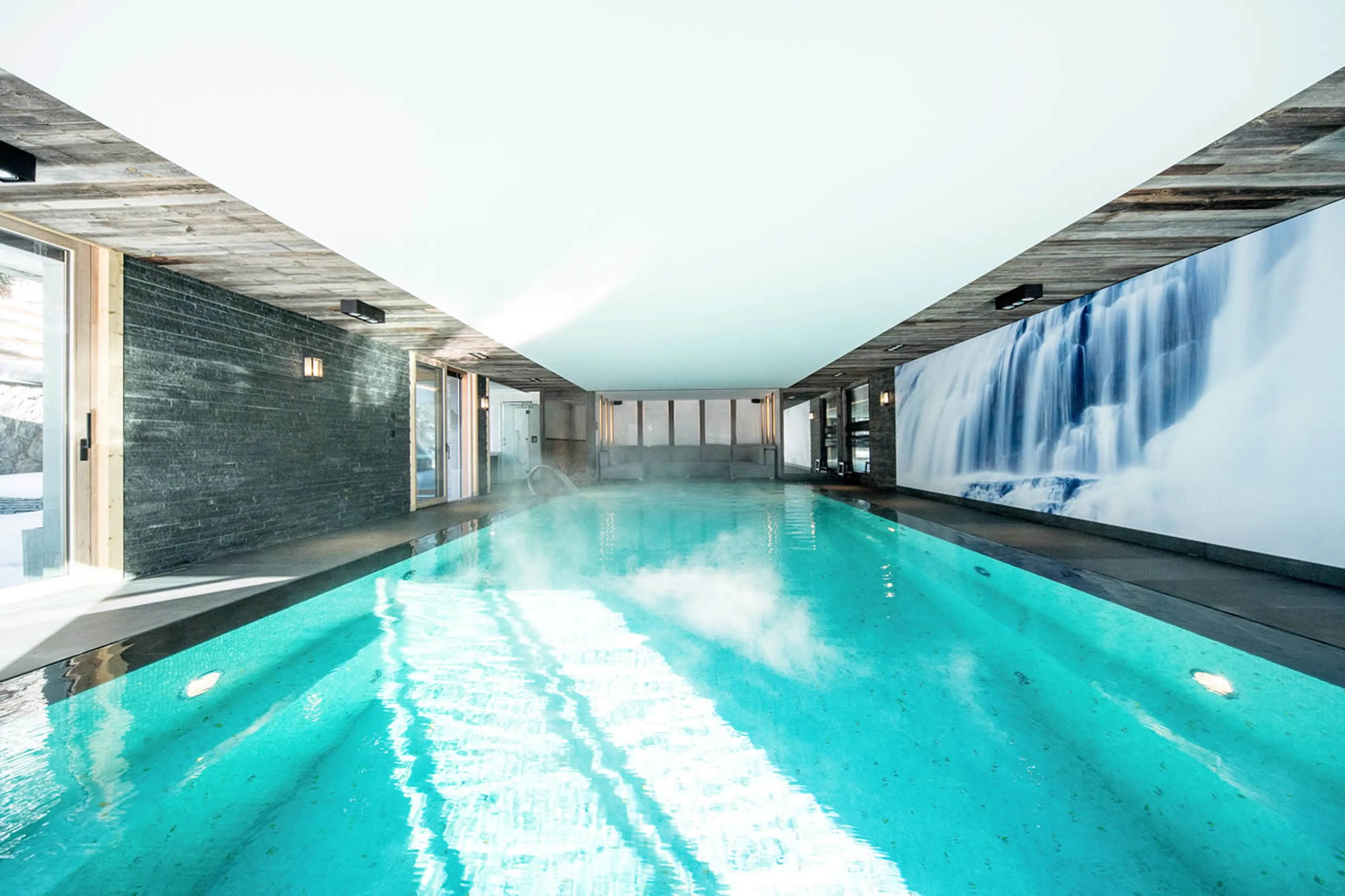 Indoor swimming pool with relaxation area in Apartment La Toula in Crans-Montana