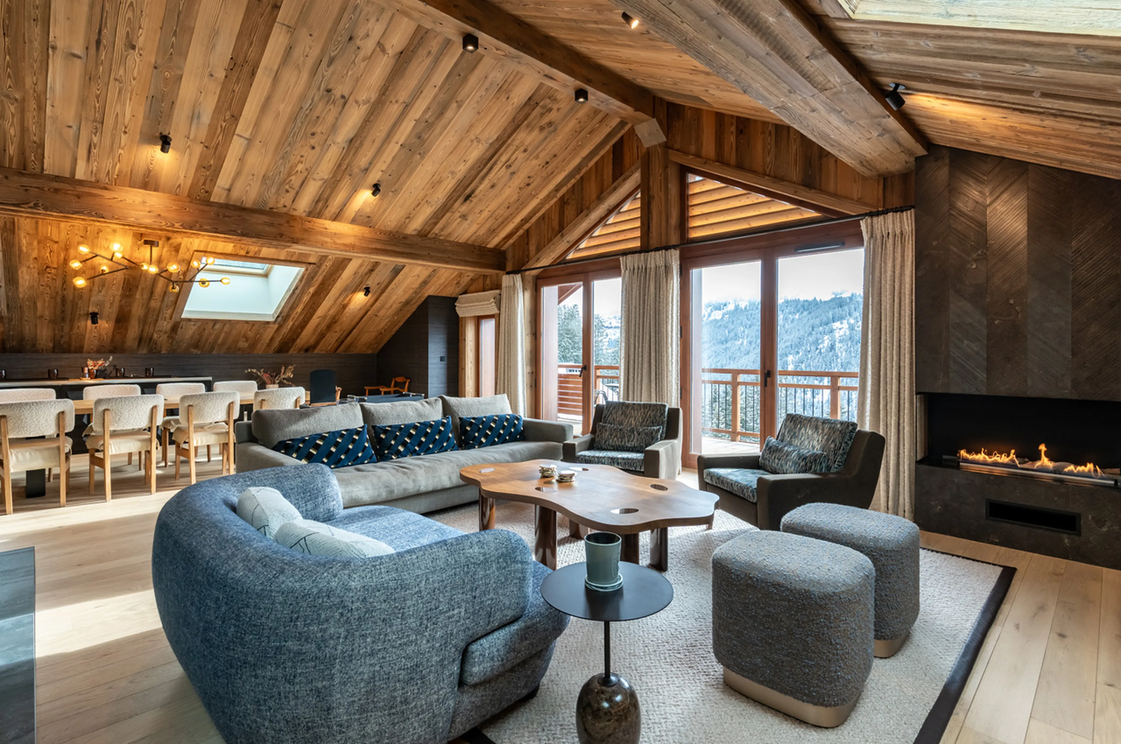 Open-plan living area with fireplace at Apartment Le Cygne in Meribel