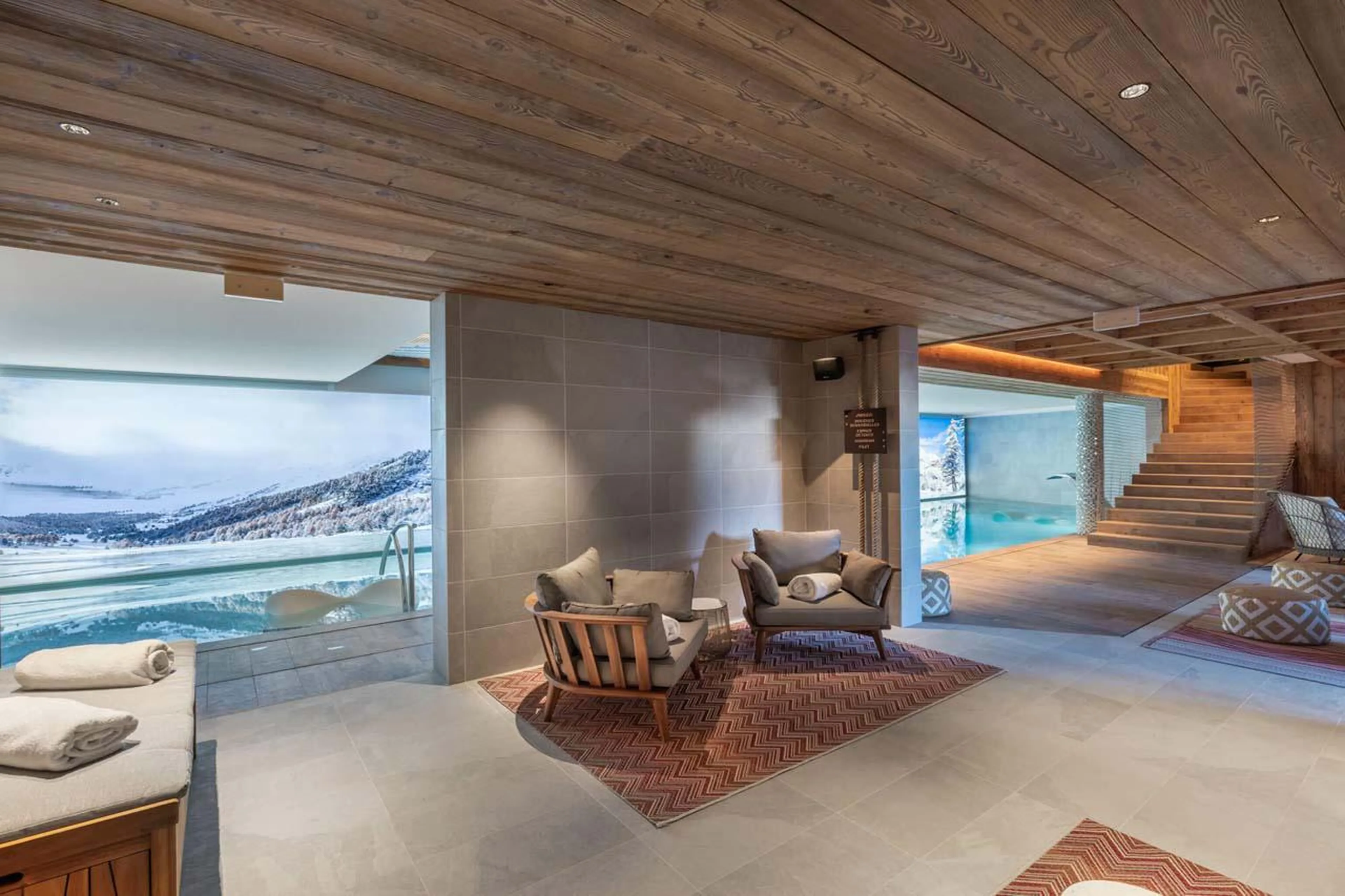 Spa with indoor swimming pool and poolside seating at Apartment Mistero in Courchevel 1850