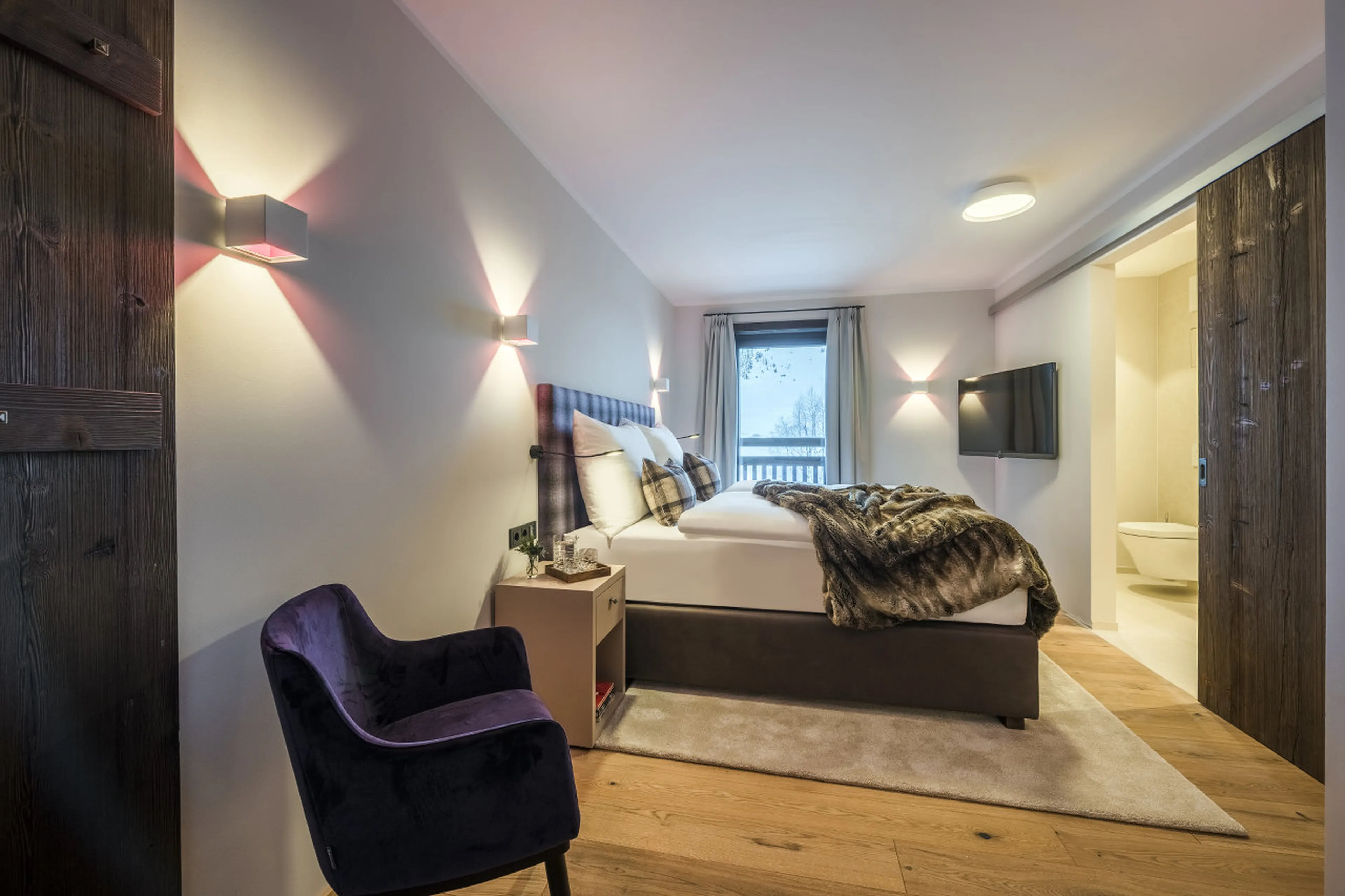 Master bedroom with TV, safe, dressing area, terrace access and en-suite shower room in Nidus Apartm