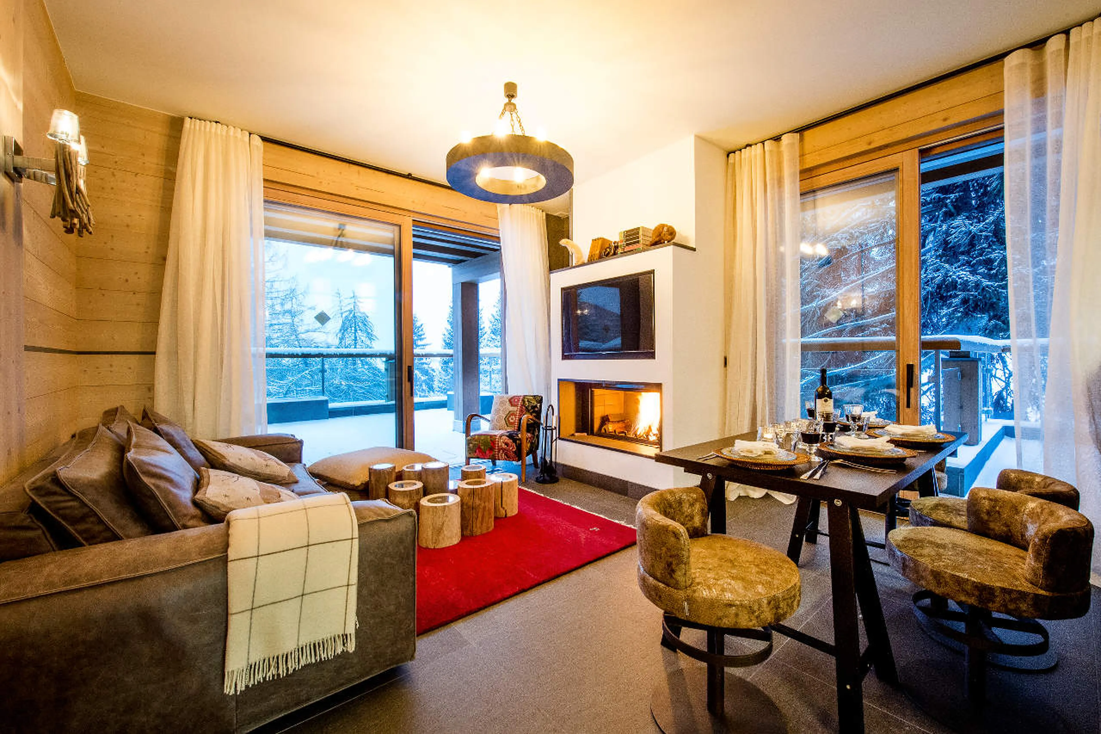Living/dining area of Apartment Violettes in Crans-Montana with fireplace, open-plan kitchen and ter