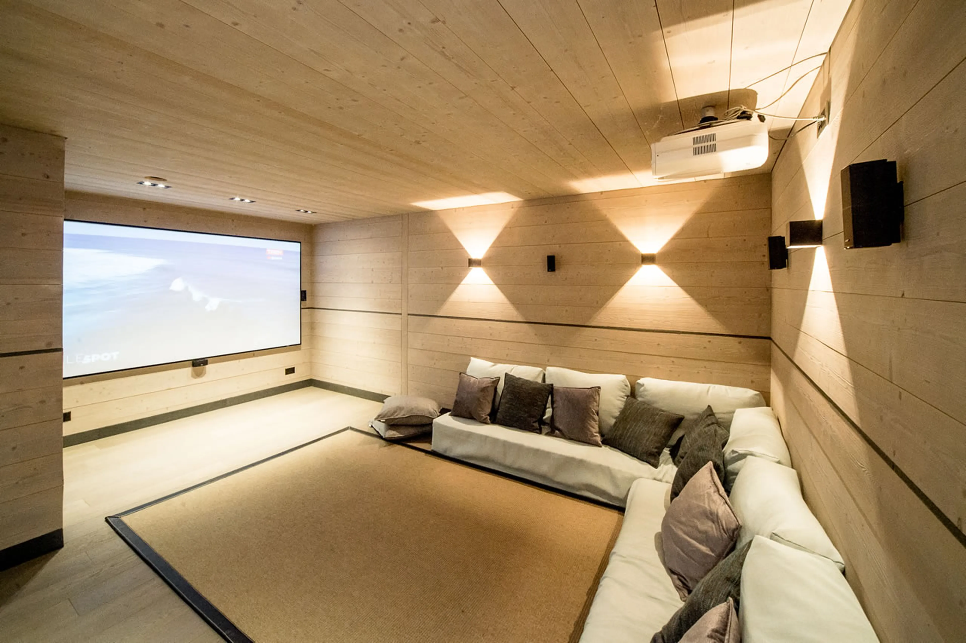 Shared cinema room for movies in Apartment Violettes in Crans-Montana