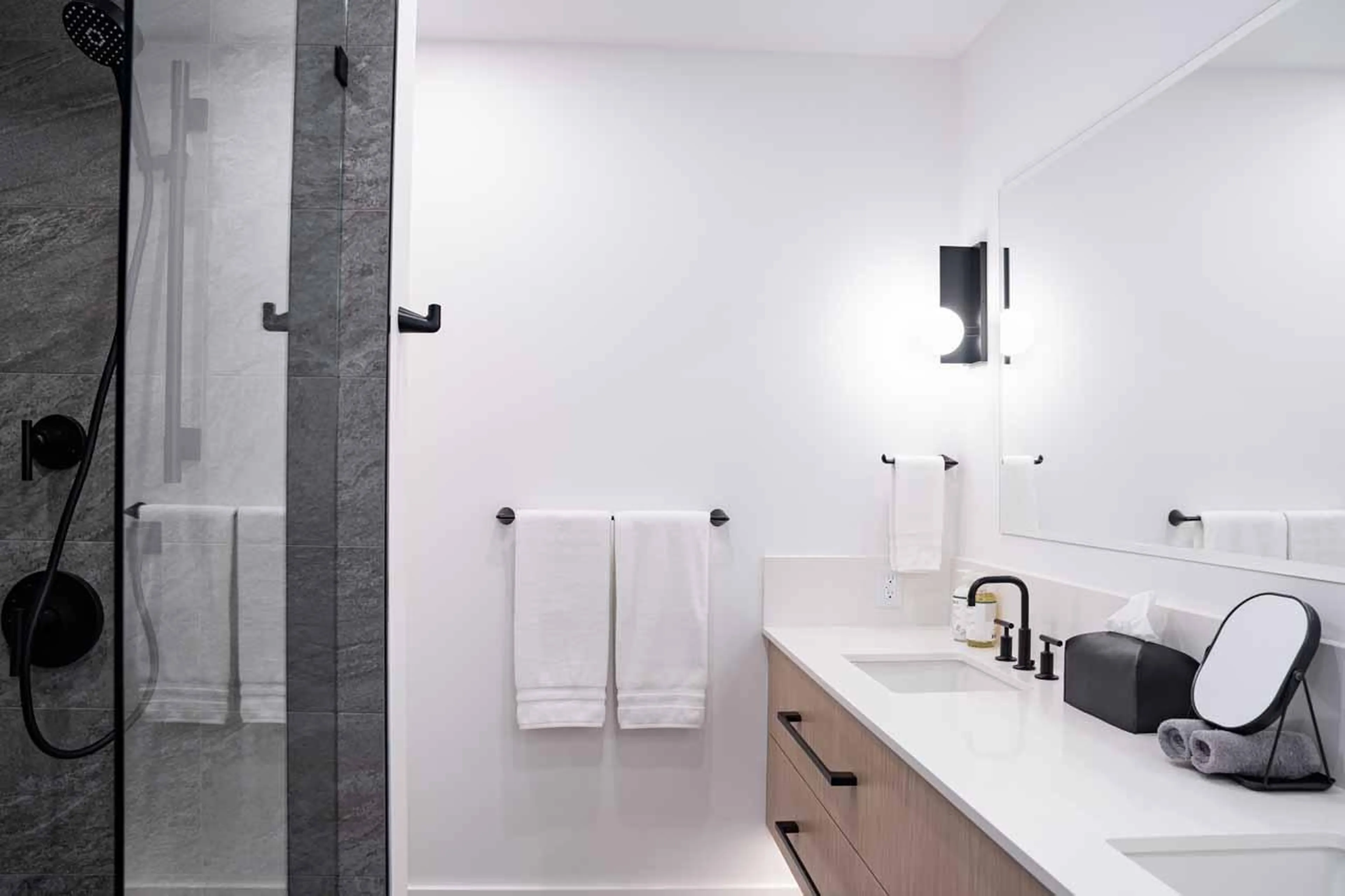 En-suite bathroom with rain shower and his and hers basins at Arrowhead Lodge in Revelstoke