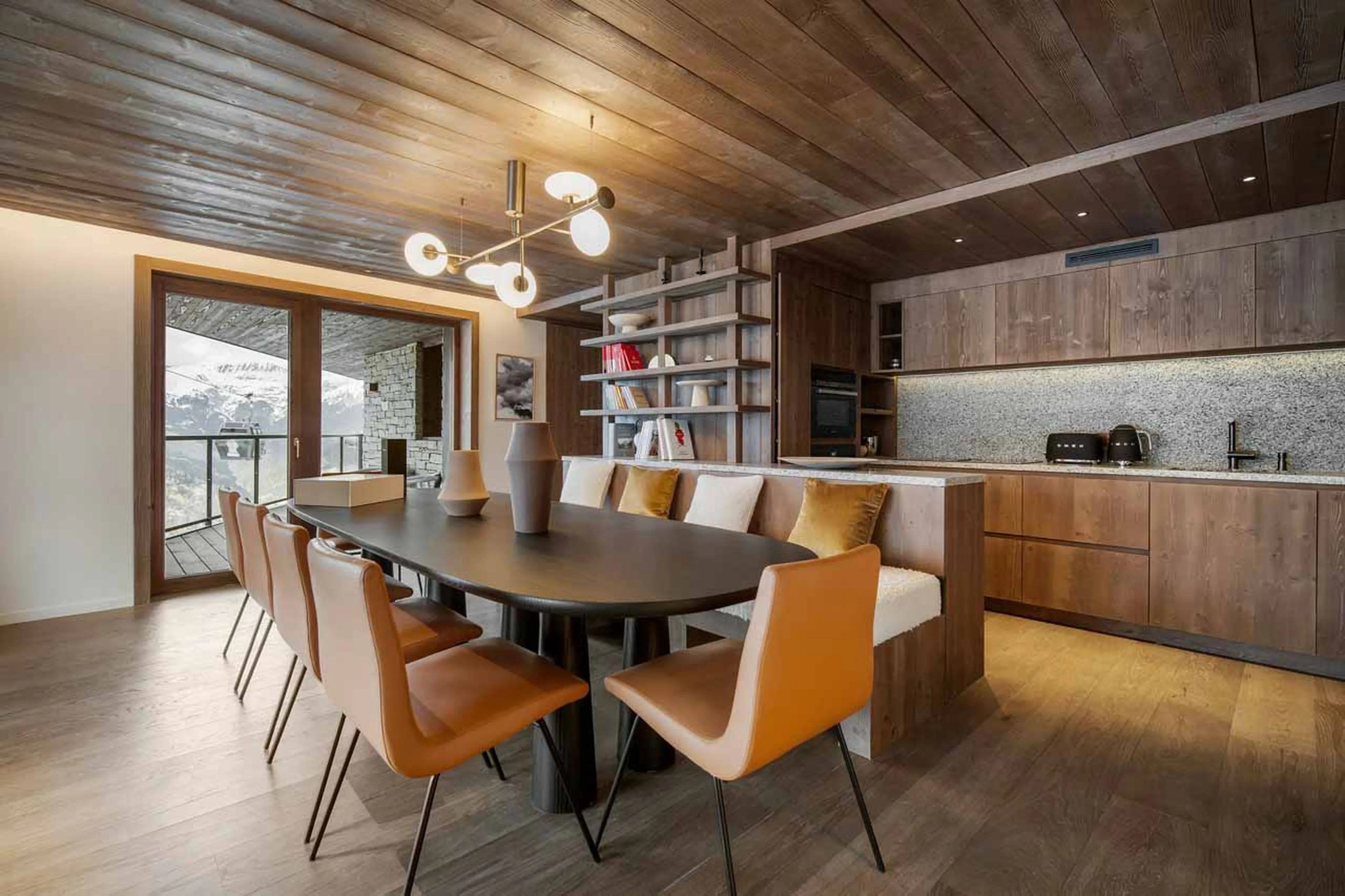 Dining table and kitchen at Atmosphere Apartment 101, Courchevel 1850