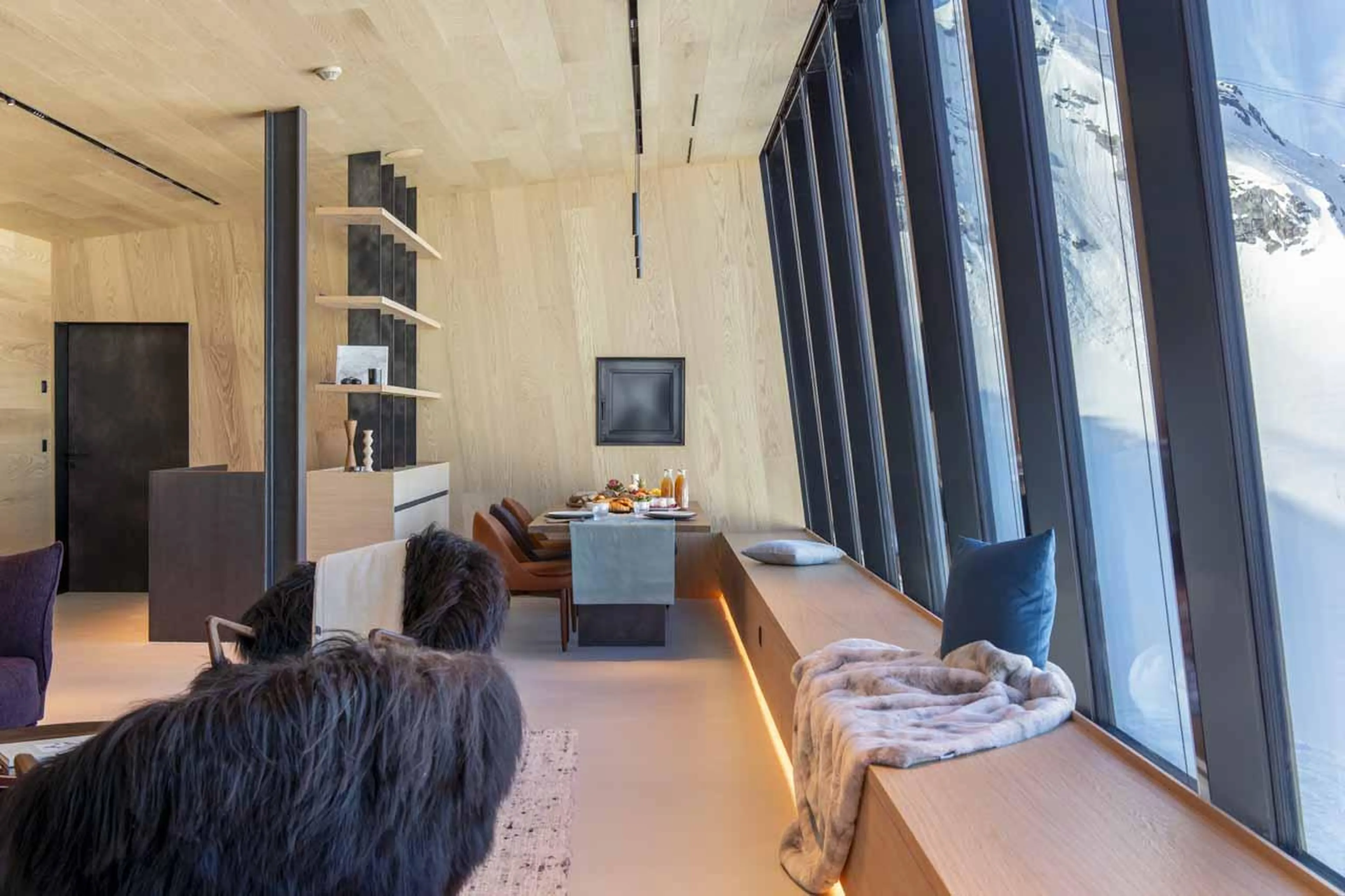 Dining area with floor-to-ceiling windows in Cabane Tortin, Verbier