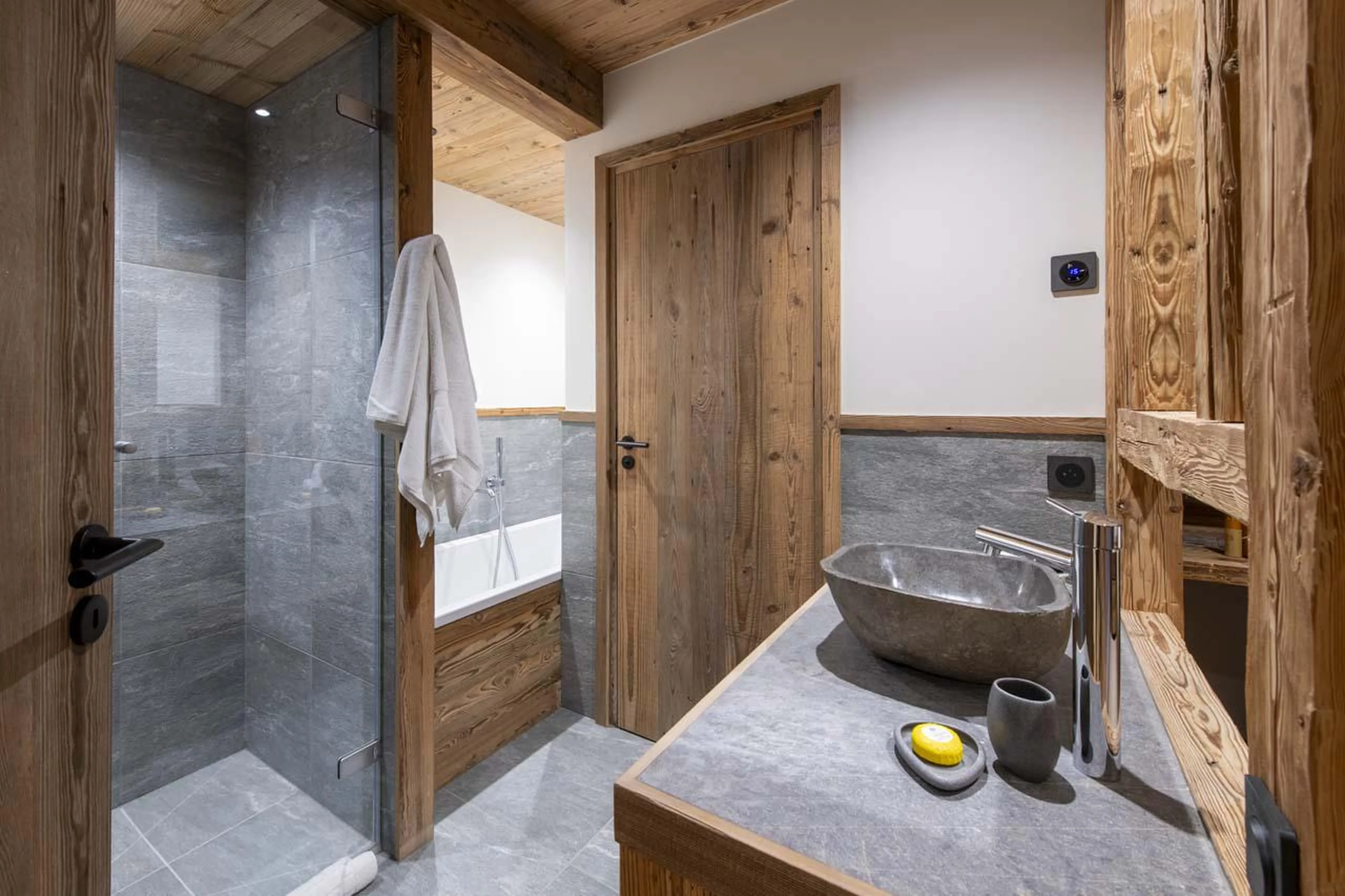 En-suite bathroom with bath and shower at Chalet 1850 in Val d'Isere