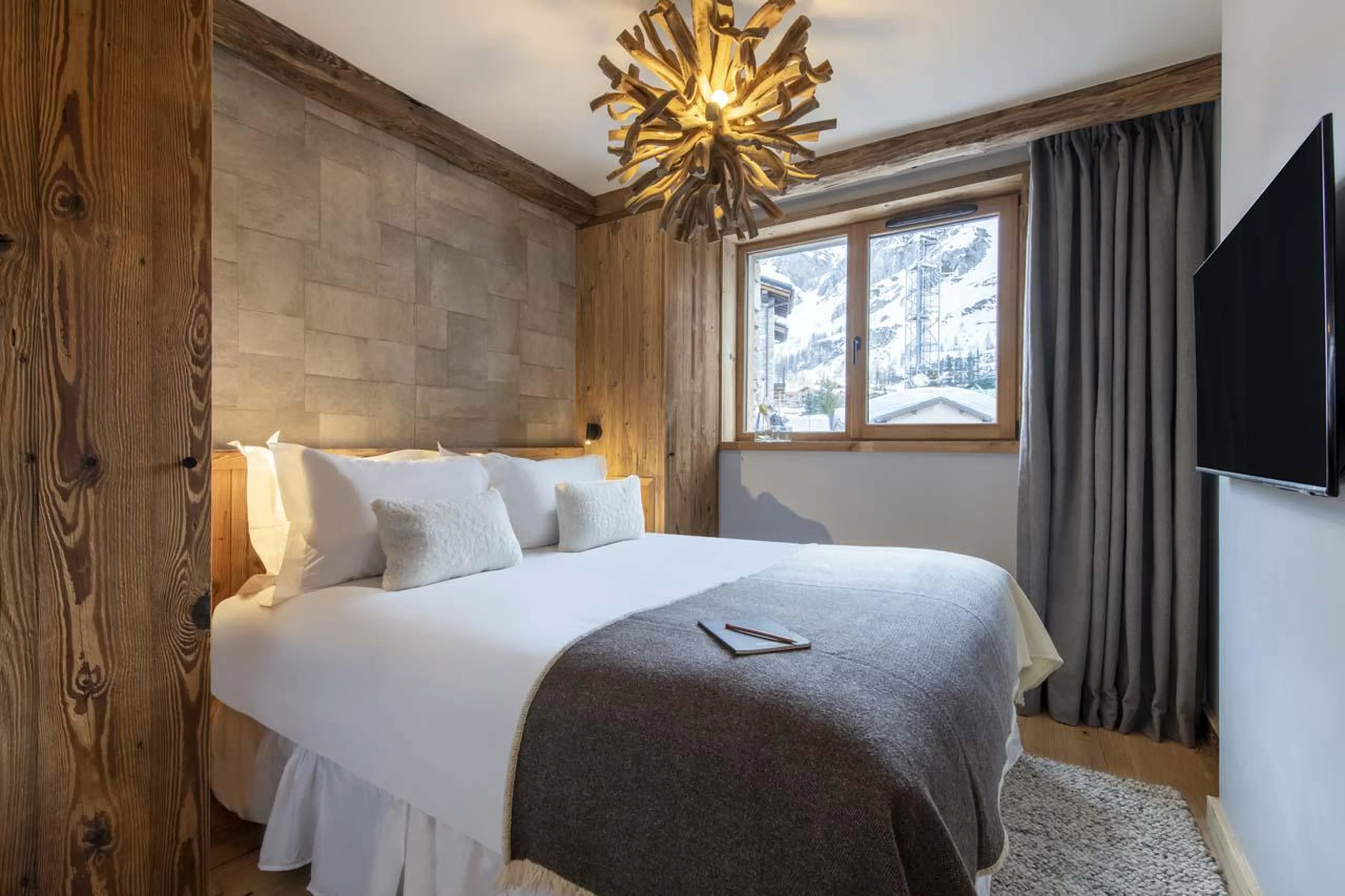 Double bedroom with TV and en-suite shower room at Chalet 1850 in Val d'Isere
