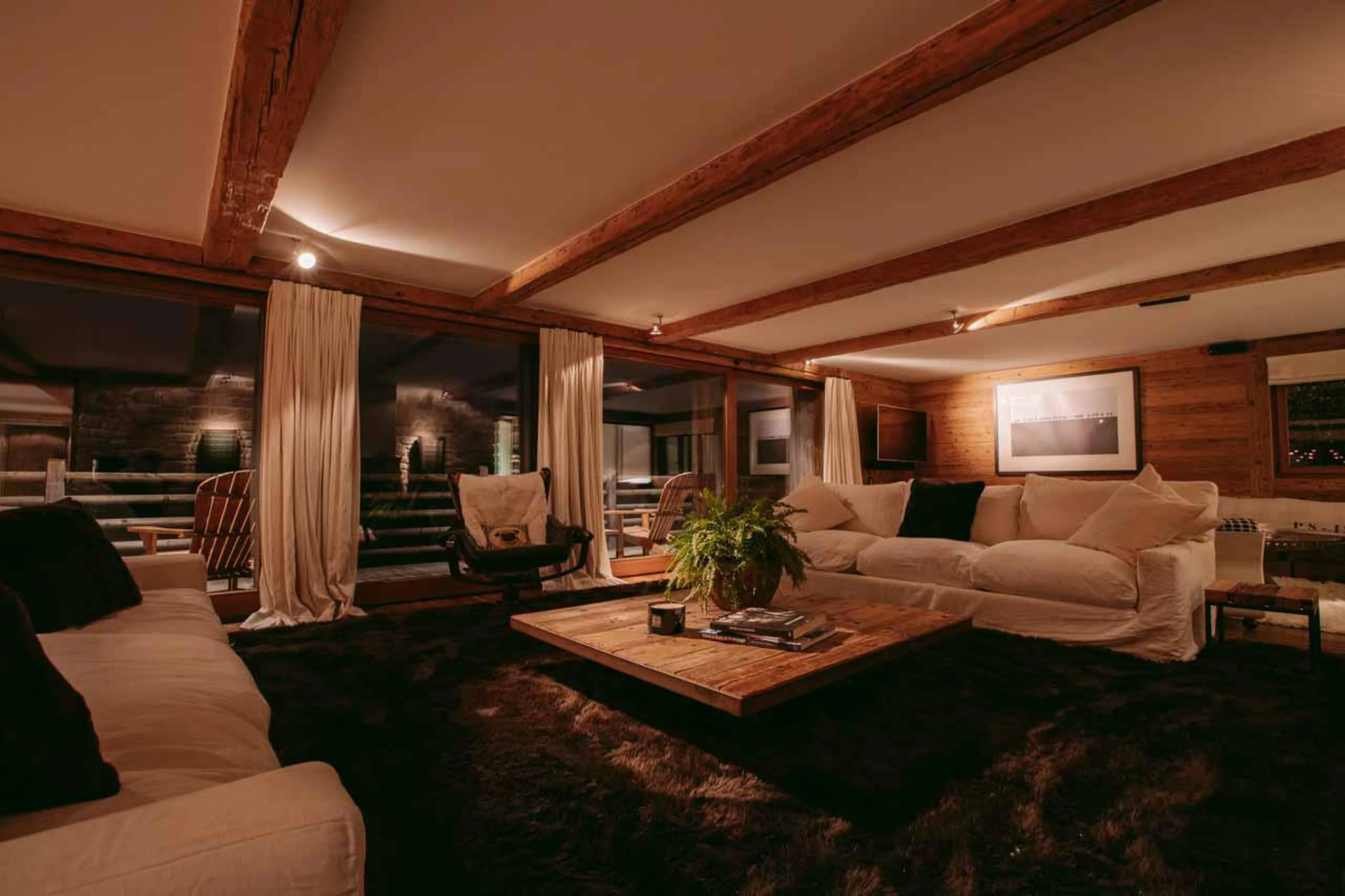 Open plan living area with terrace access at Chalet 1936 in Verbier