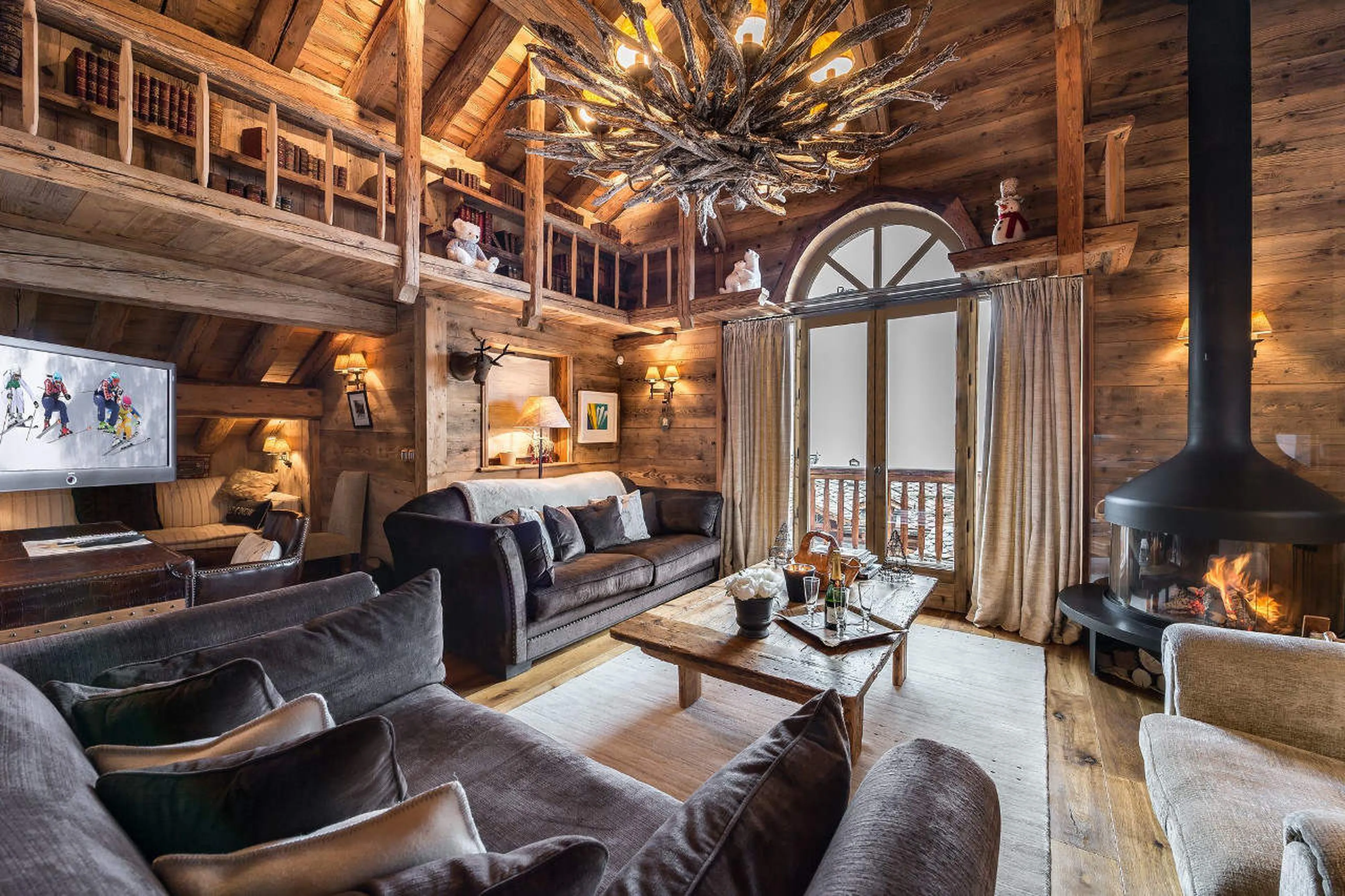 Mountain facing lounge with fireplace in Chalet 3 Soeurs in Courchevel 1850