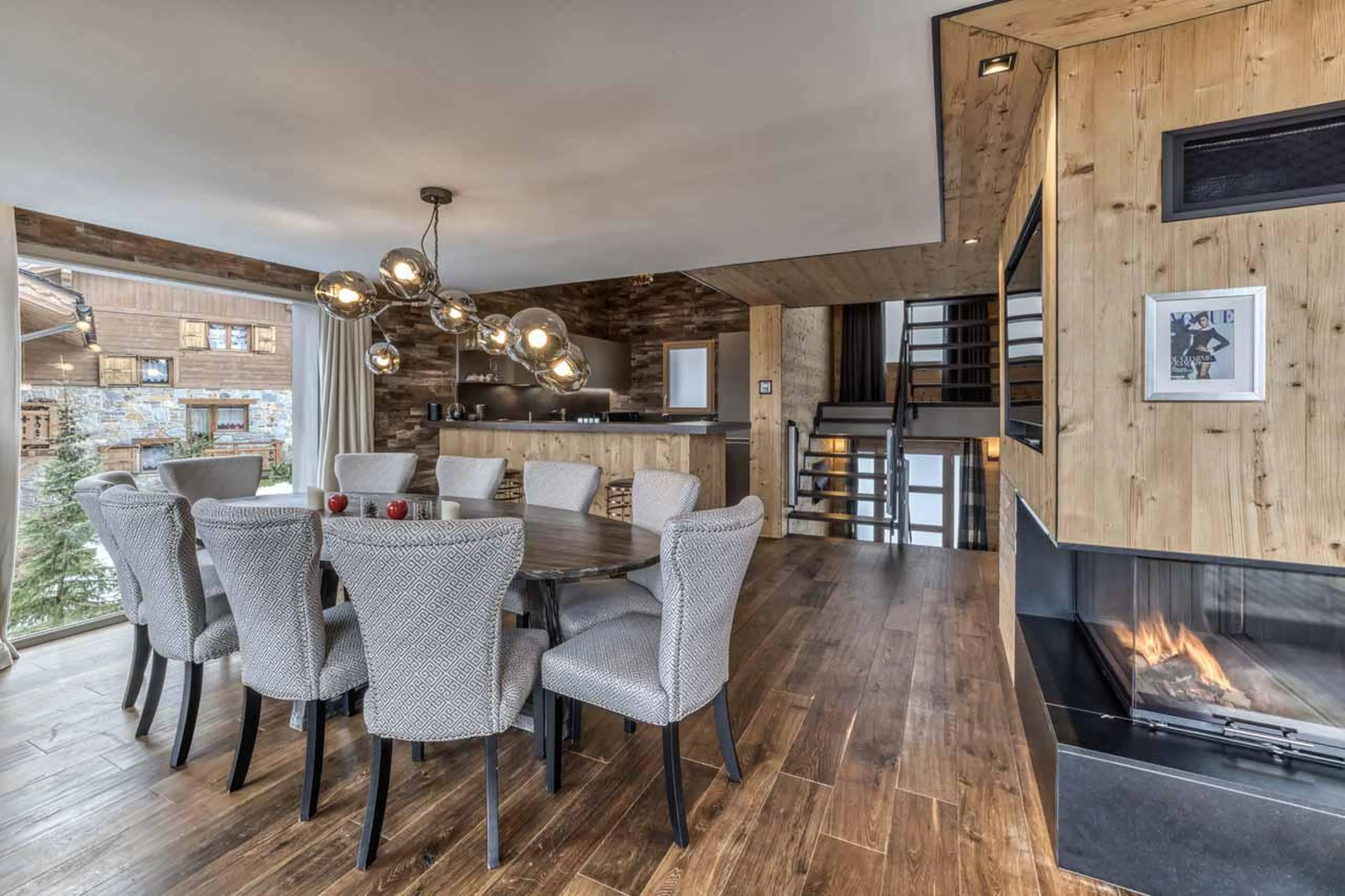 Dining space with access to open kitchen space at Chalet Acelia in Courchevel 1550