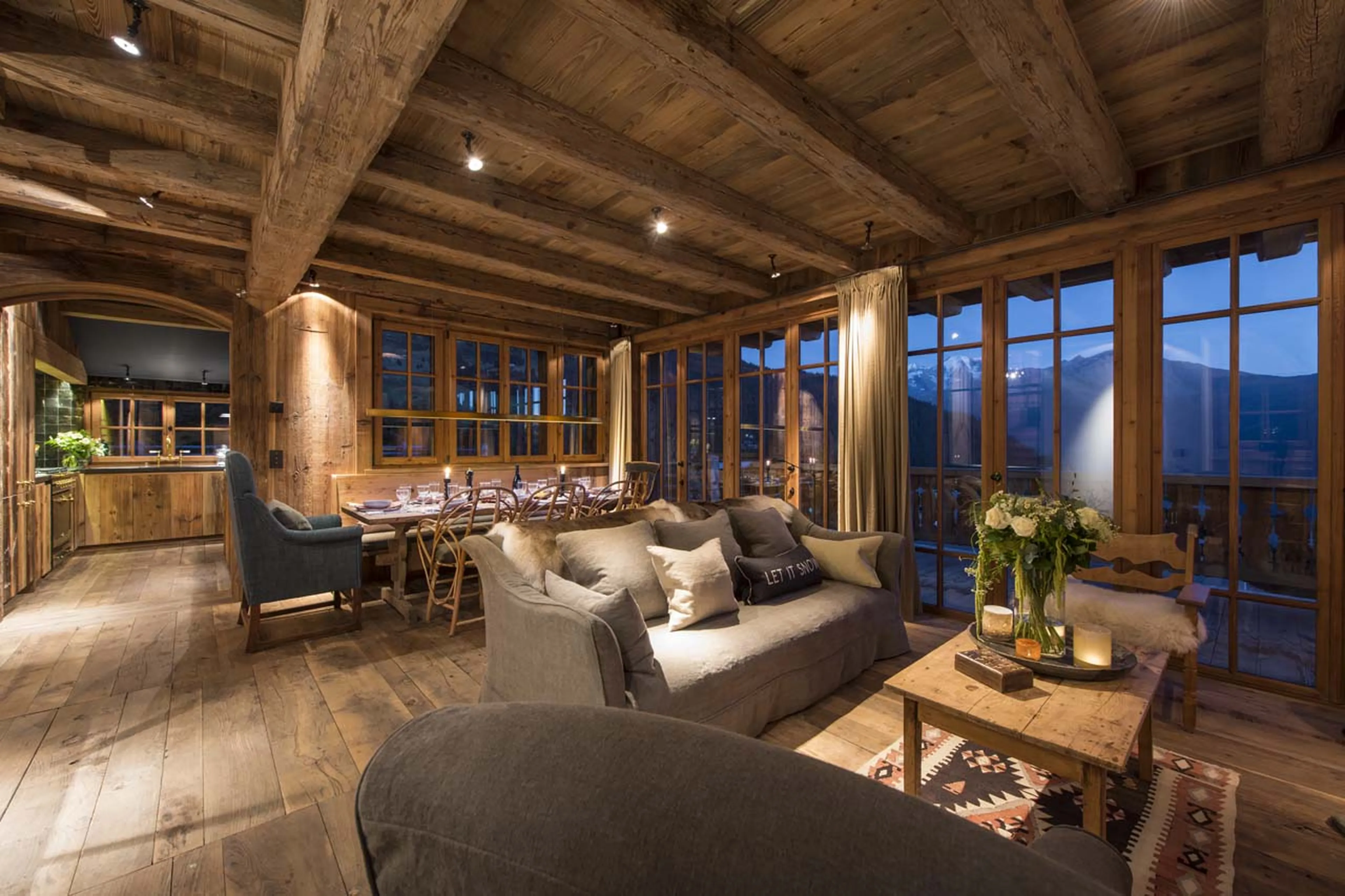 Open plan living area at night of Chalet Aline in Verbier