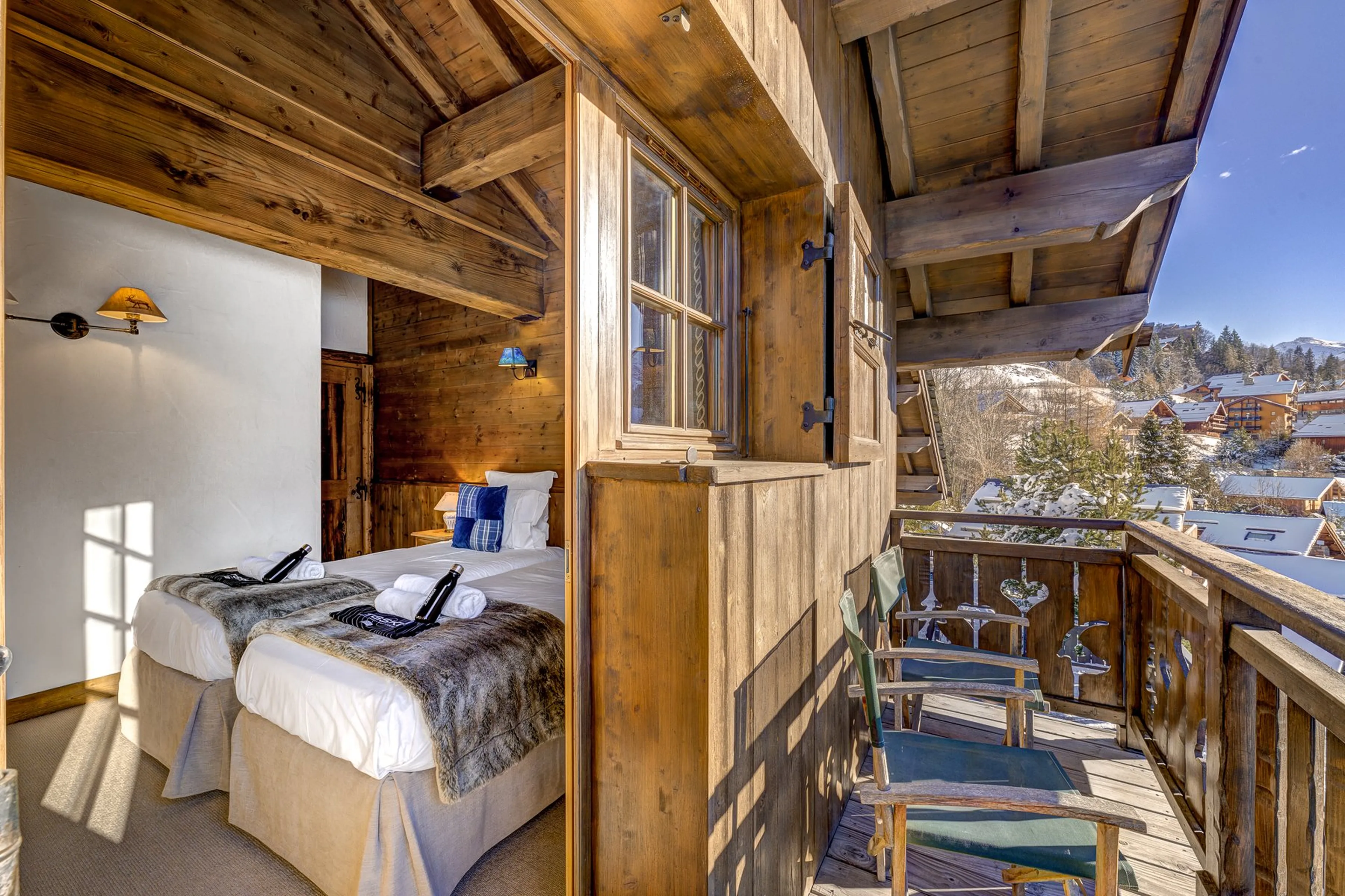 Bedroom two with private balcony at Chalet Amarena in Meribel