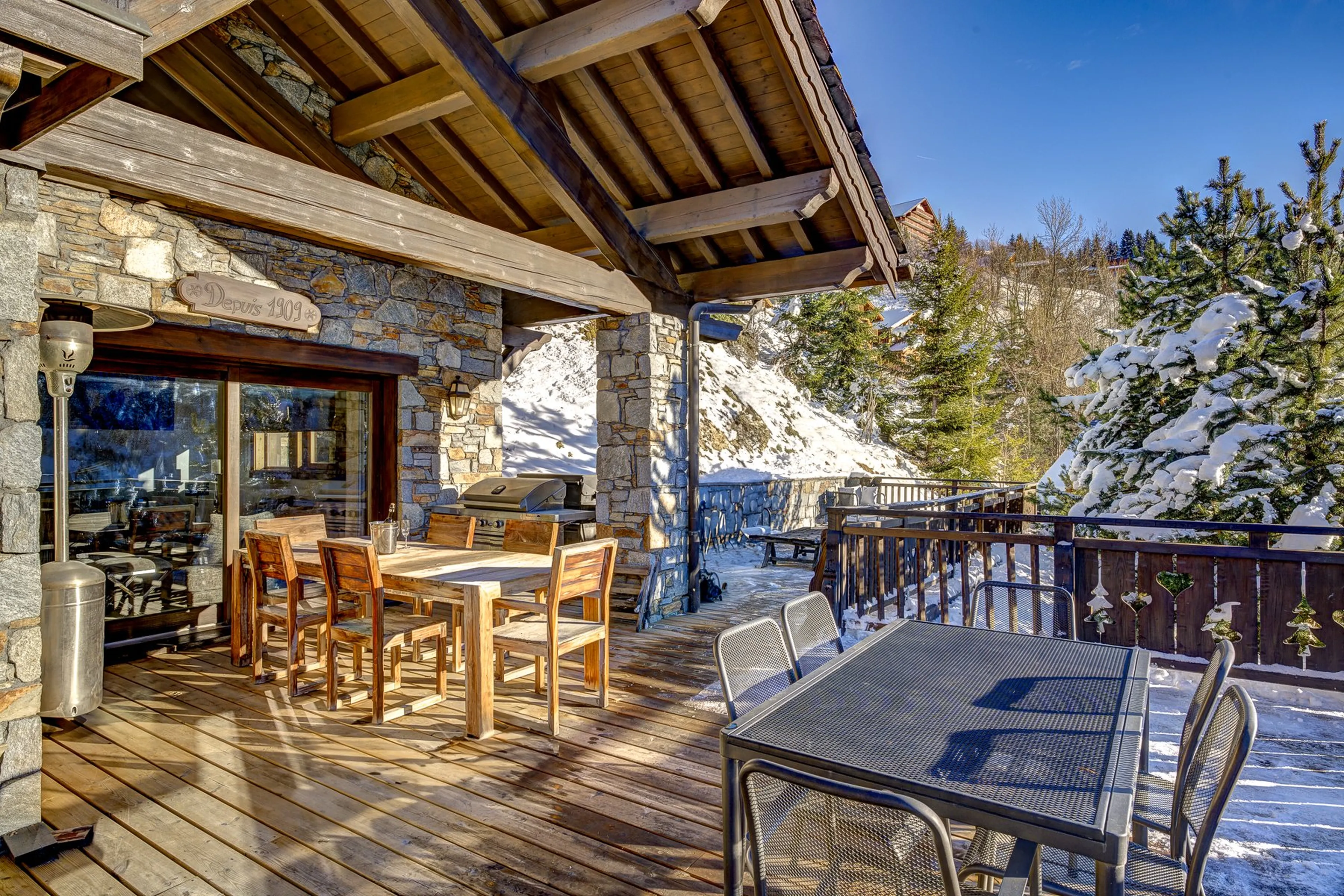 Terrace with dining table at Chalet Amarena in Meribel