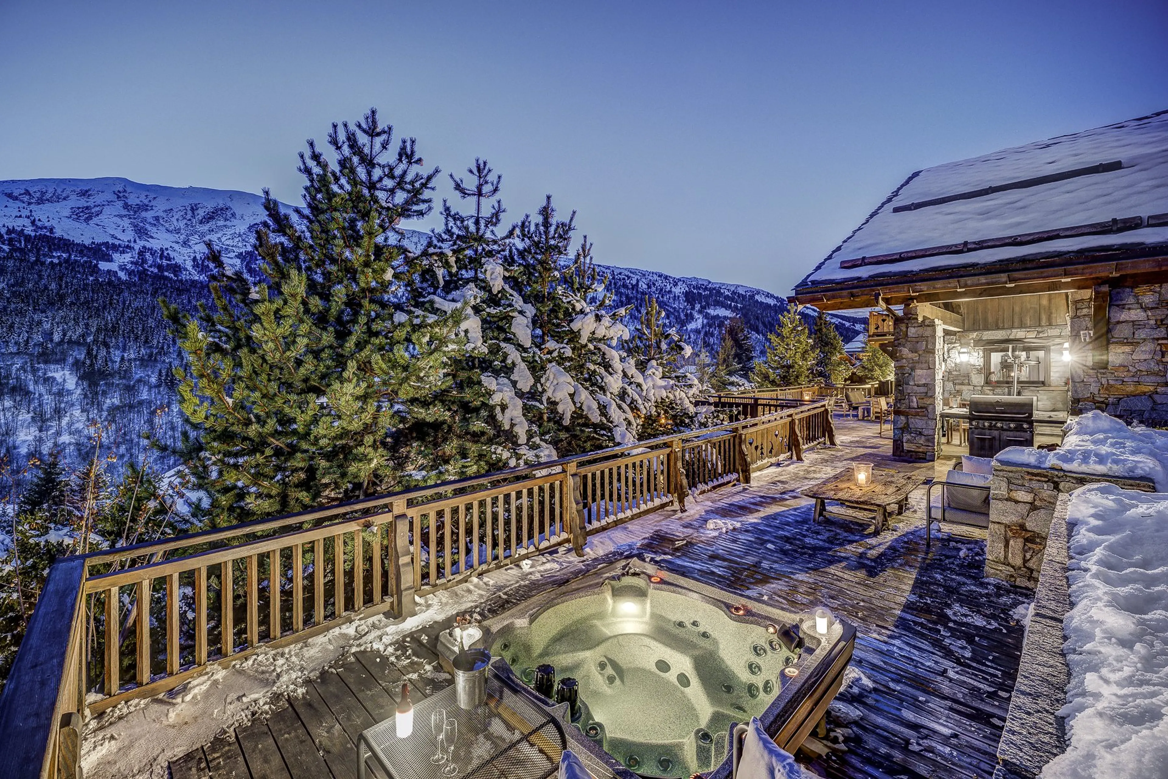 Terrace and hot tub at night at Chalet Amarena in Meribel
