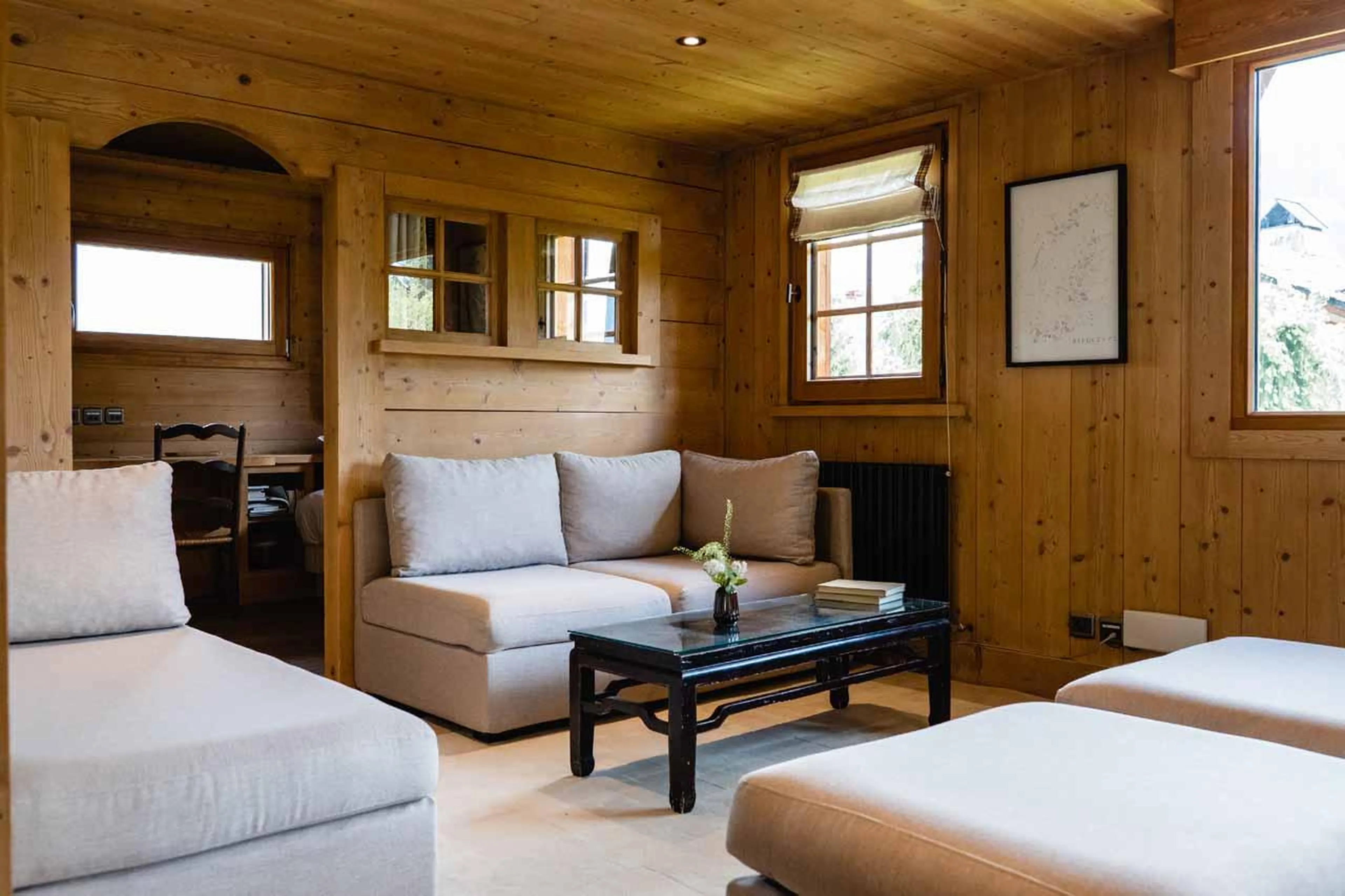 Sofas and armchairs surrounding coffee table in Chalet Ambroise, Megeve