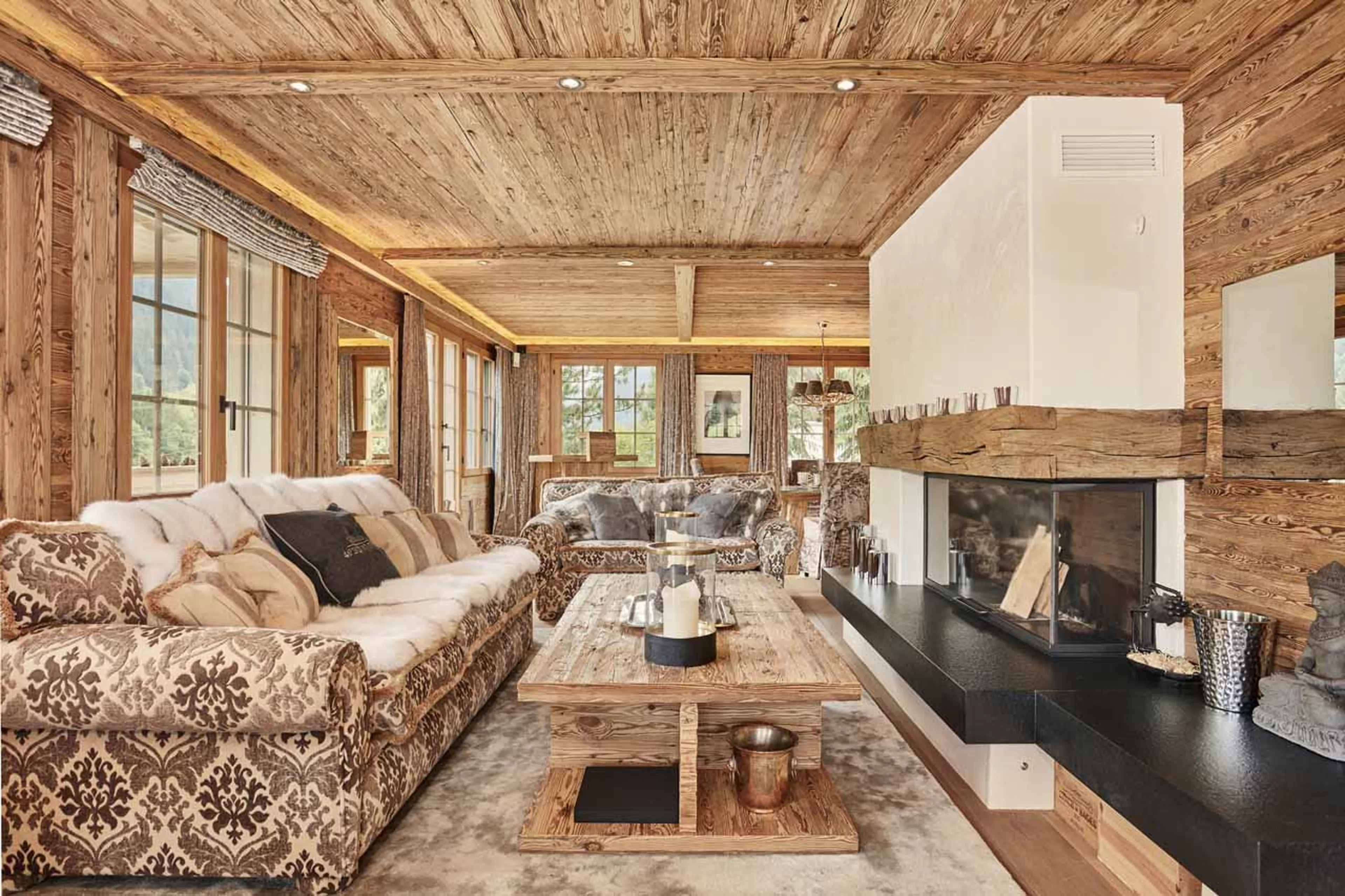 Living room with fireplace at Chalet Amorica in Gstaad