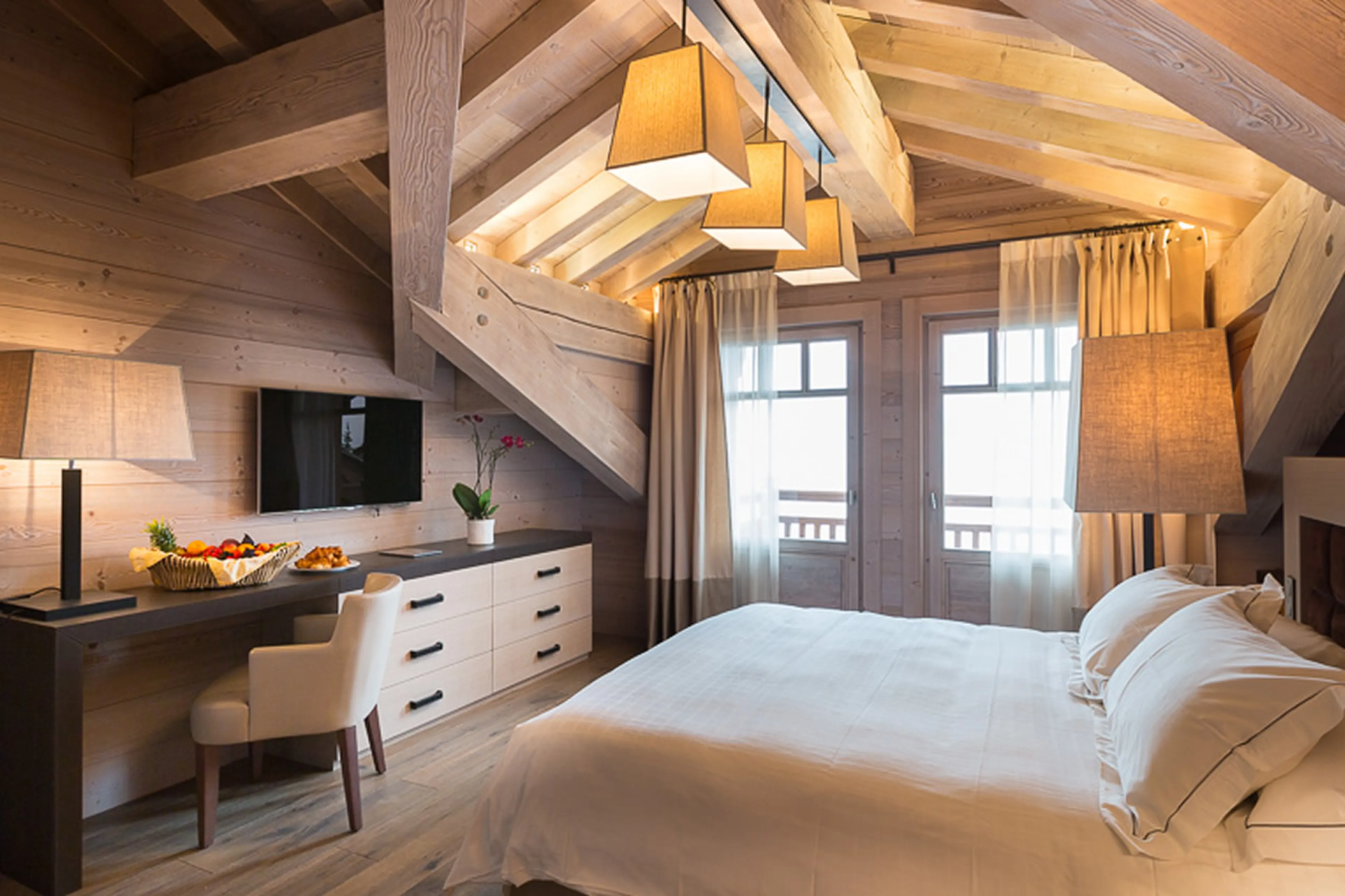 En suite master bedroom with dressing room and balcony access in Chalet Anemone in Courchevel 1850