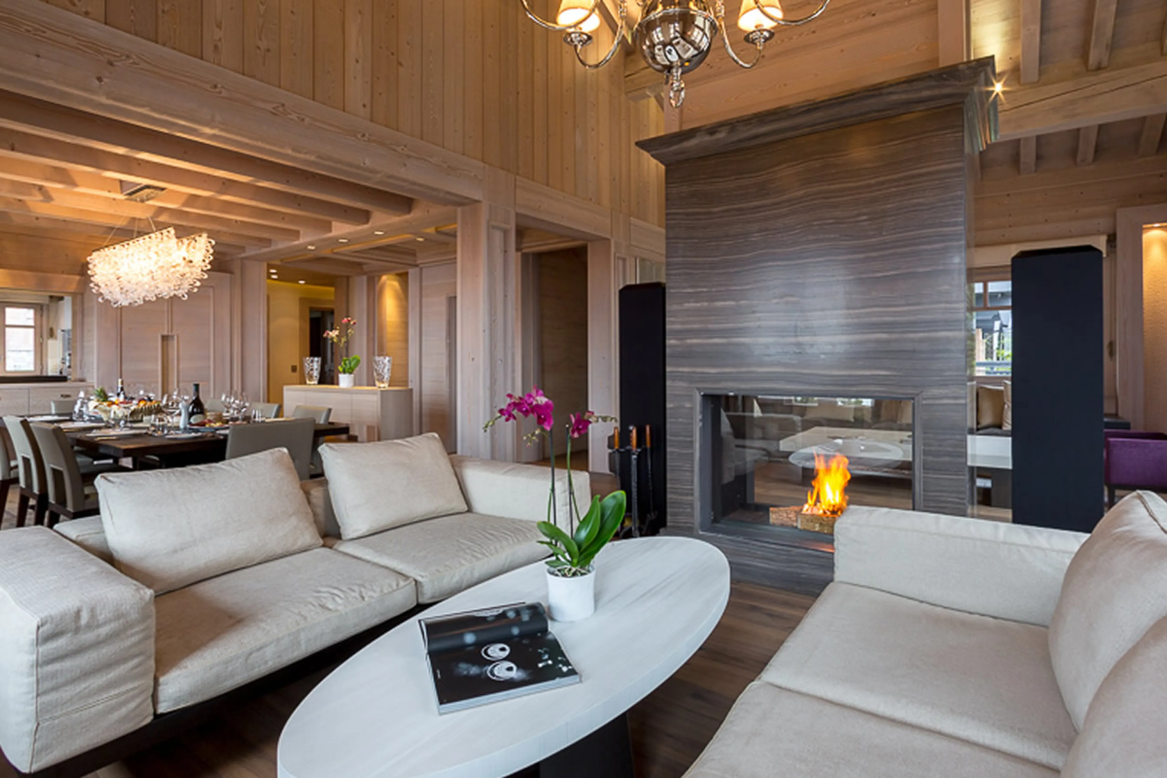 Lounge with comfortable central fireplace in Chalet Anemone in Courchevel 1850