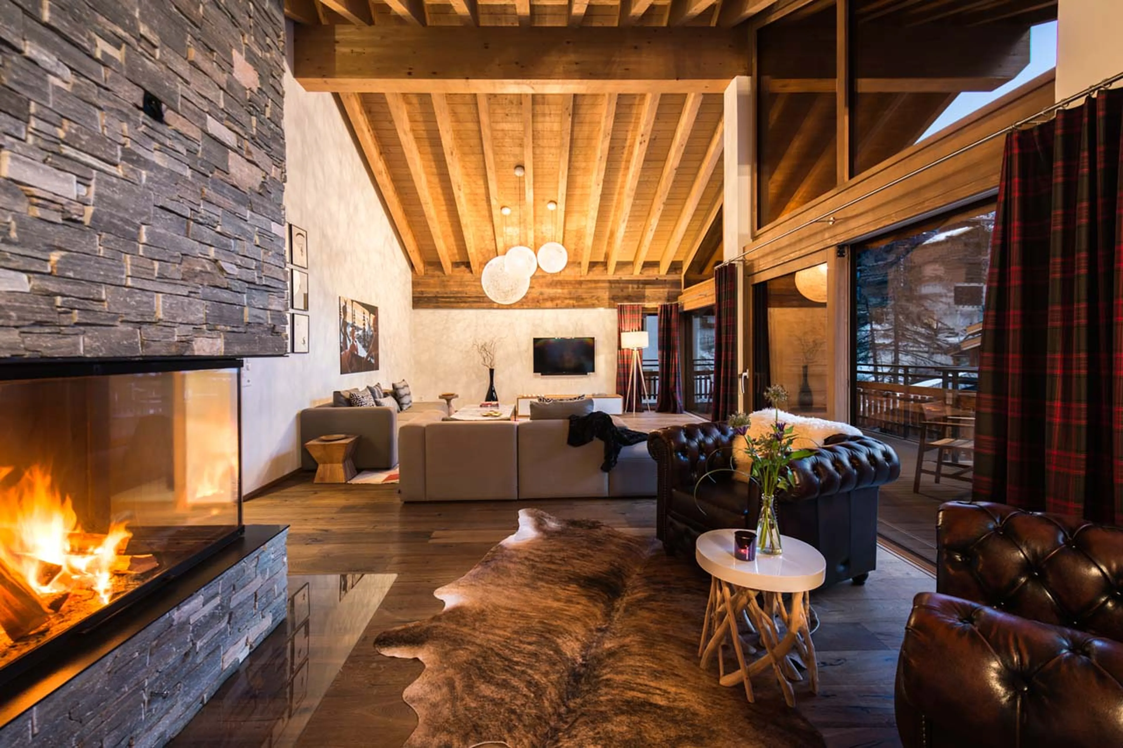 Living area at night at Penthouse Aria in Zermatt