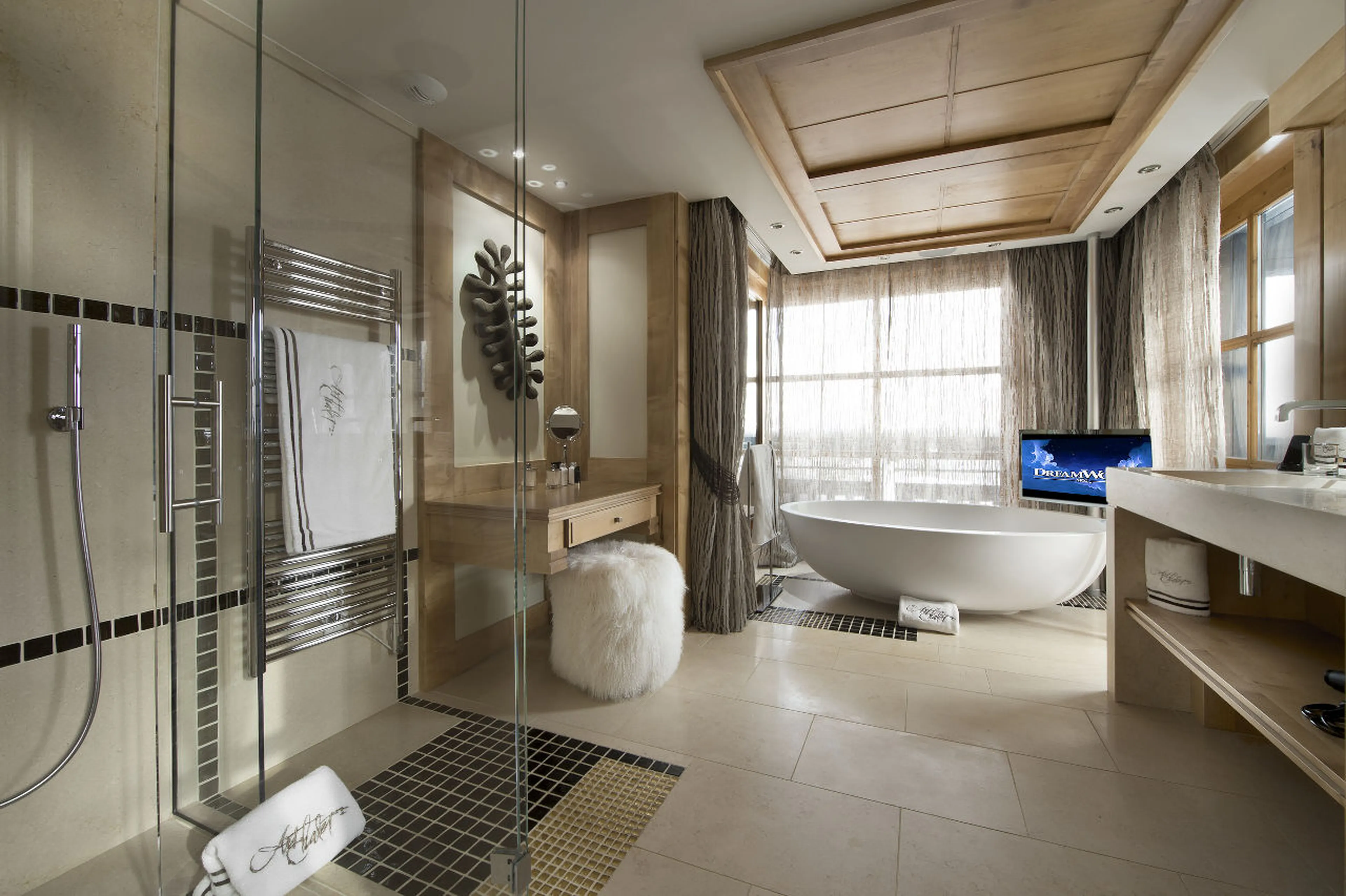 Chalet Art in Courchevel 1850 boasts an oval bath and double basin in this bathroom