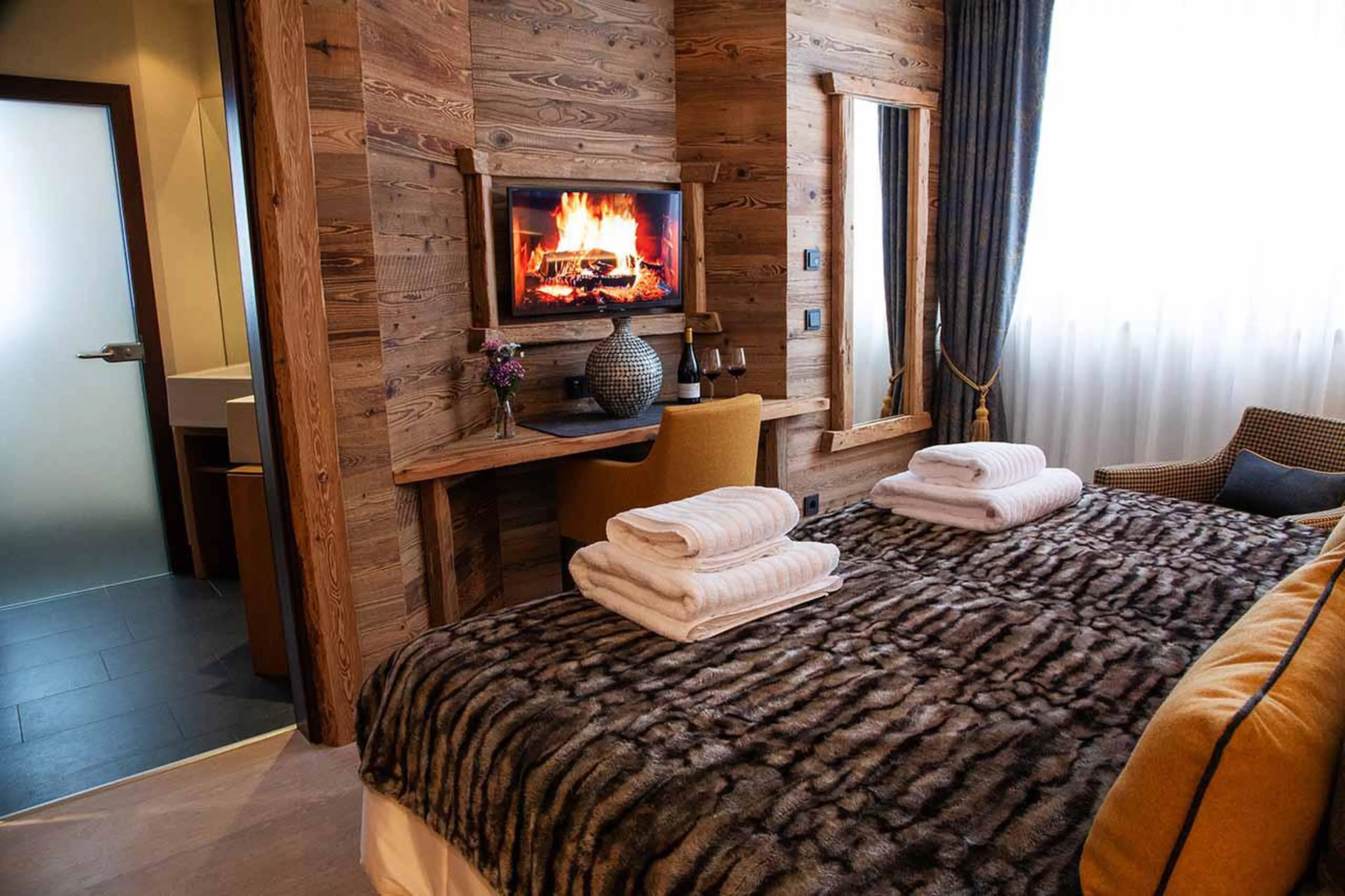 Desk and TV in bedroom six at Chalet Artemis in St Anton