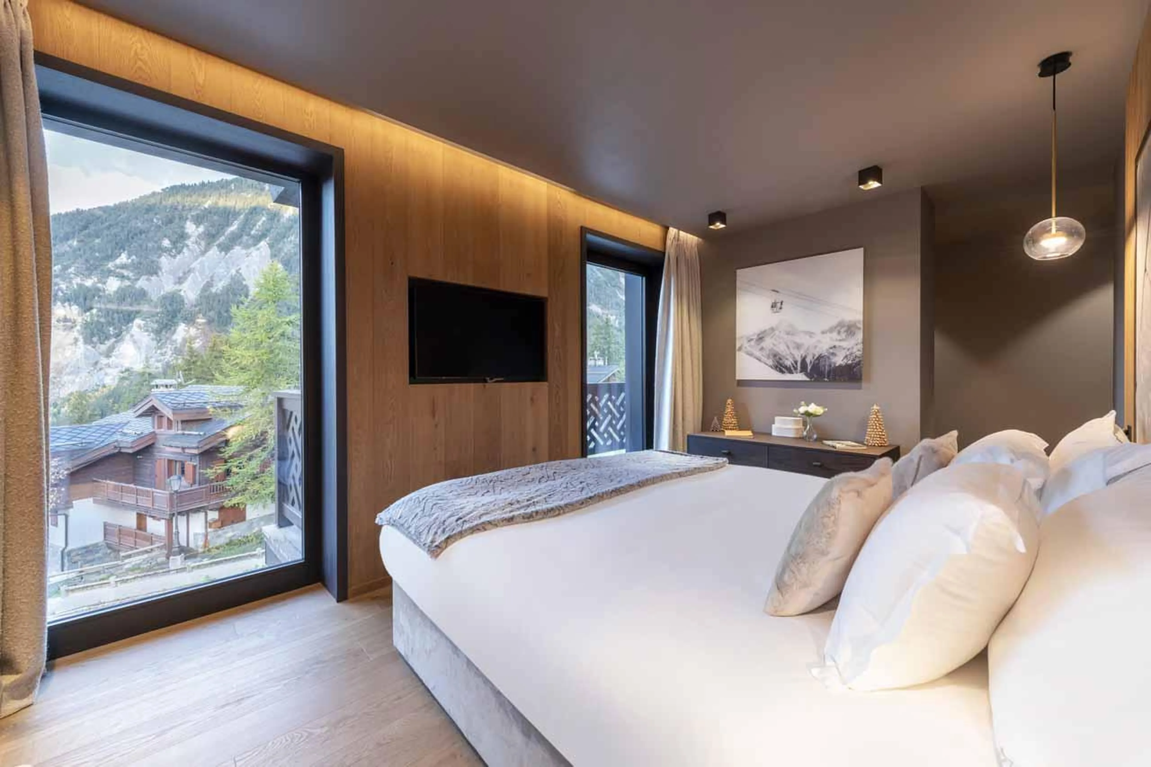 Double bedroom with two floor-to-ceiling windows in Chalet Ascension, Courchevel 1650