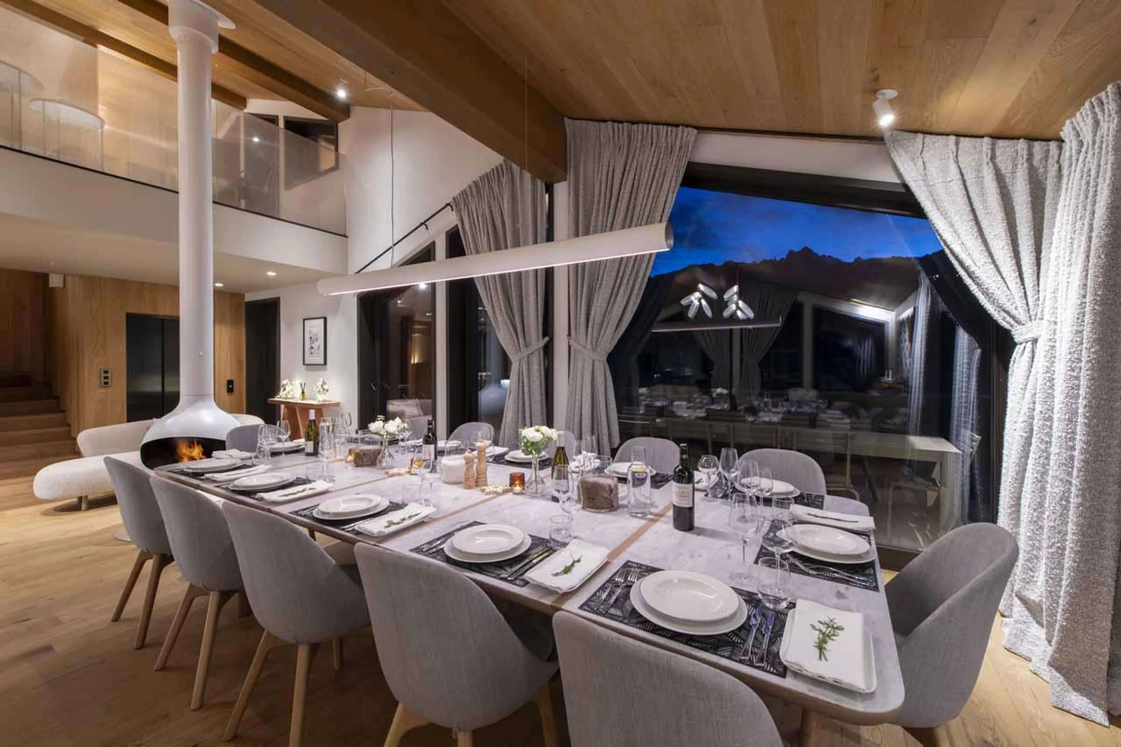 Dining table and hanging fireplace in Chalet Ascension, Courchevel 1650